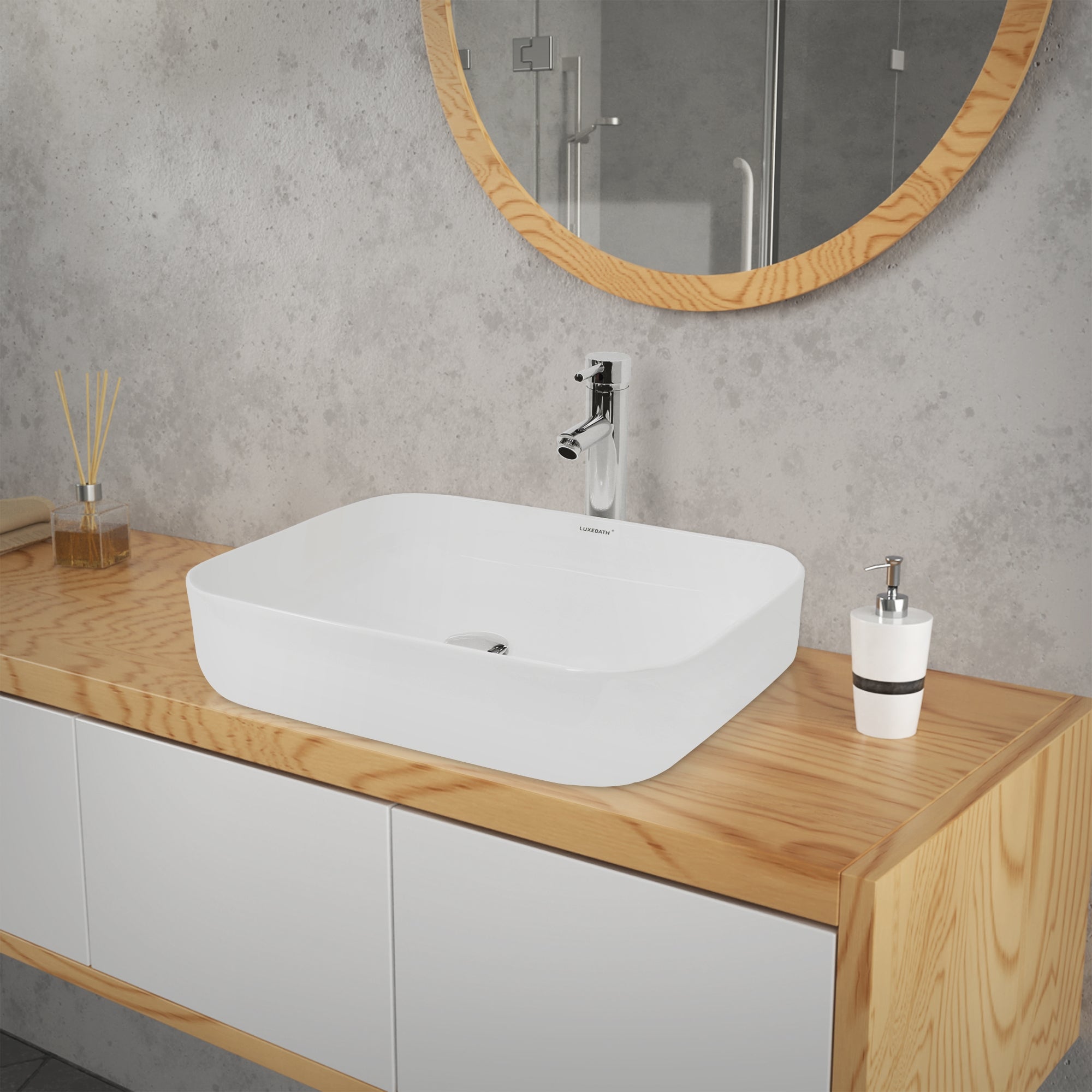 Sink on a wooden shelf with round mirror and bathroom elements.