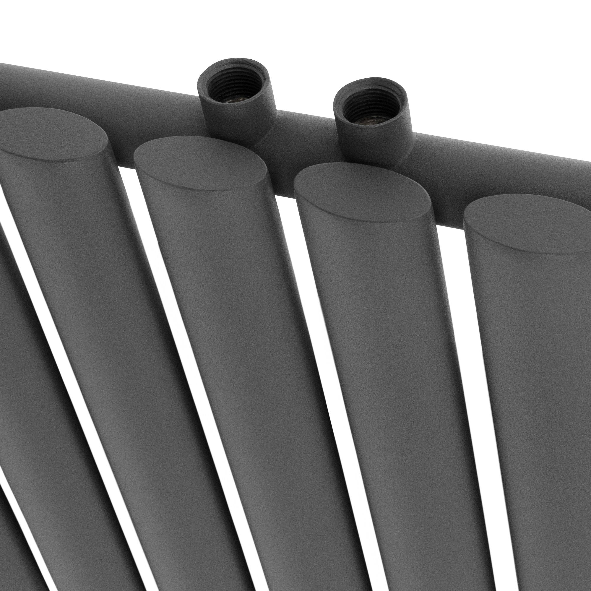 Close-up of the pipes of an anthracite-colored radiator.