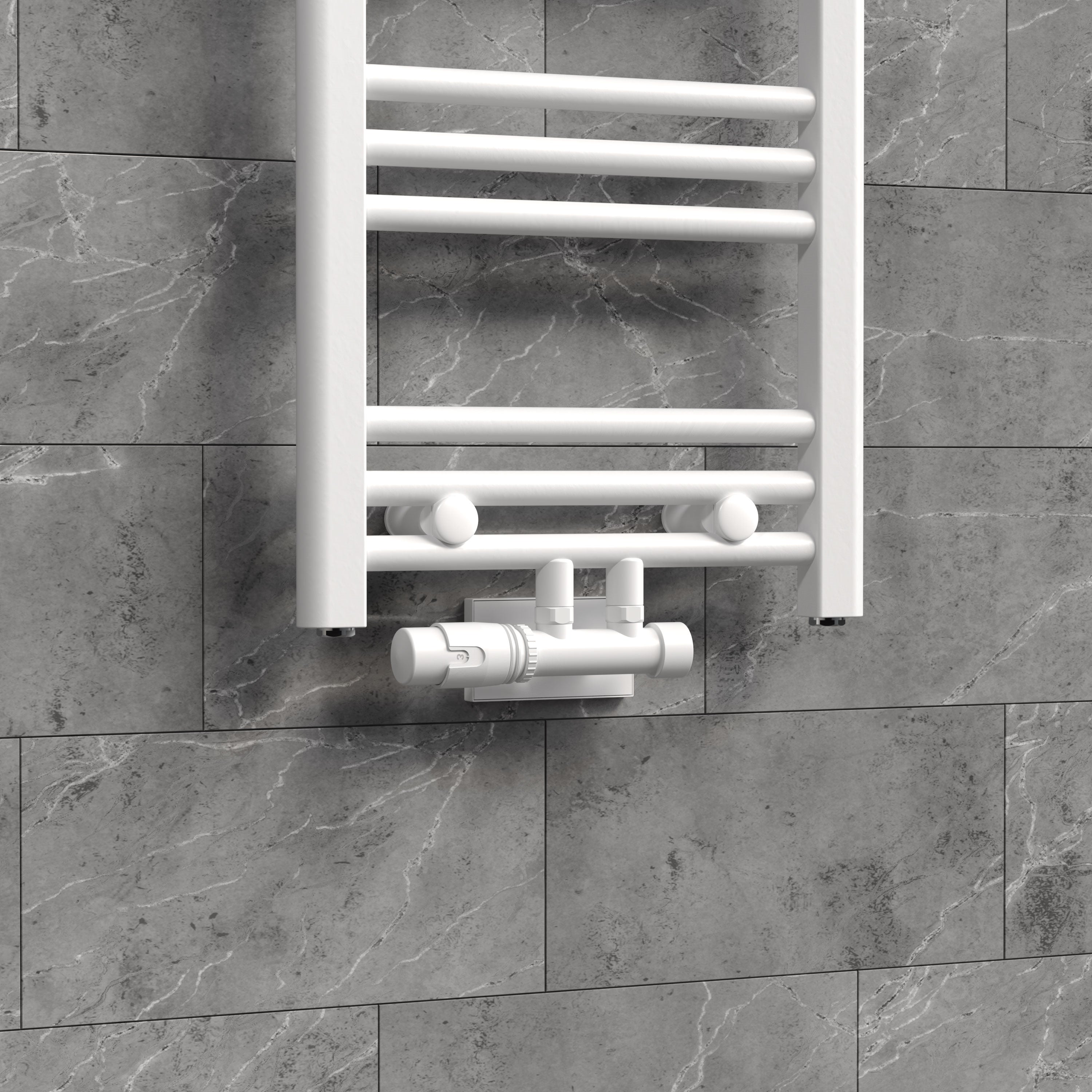 Radiator with white valve on gray wall.