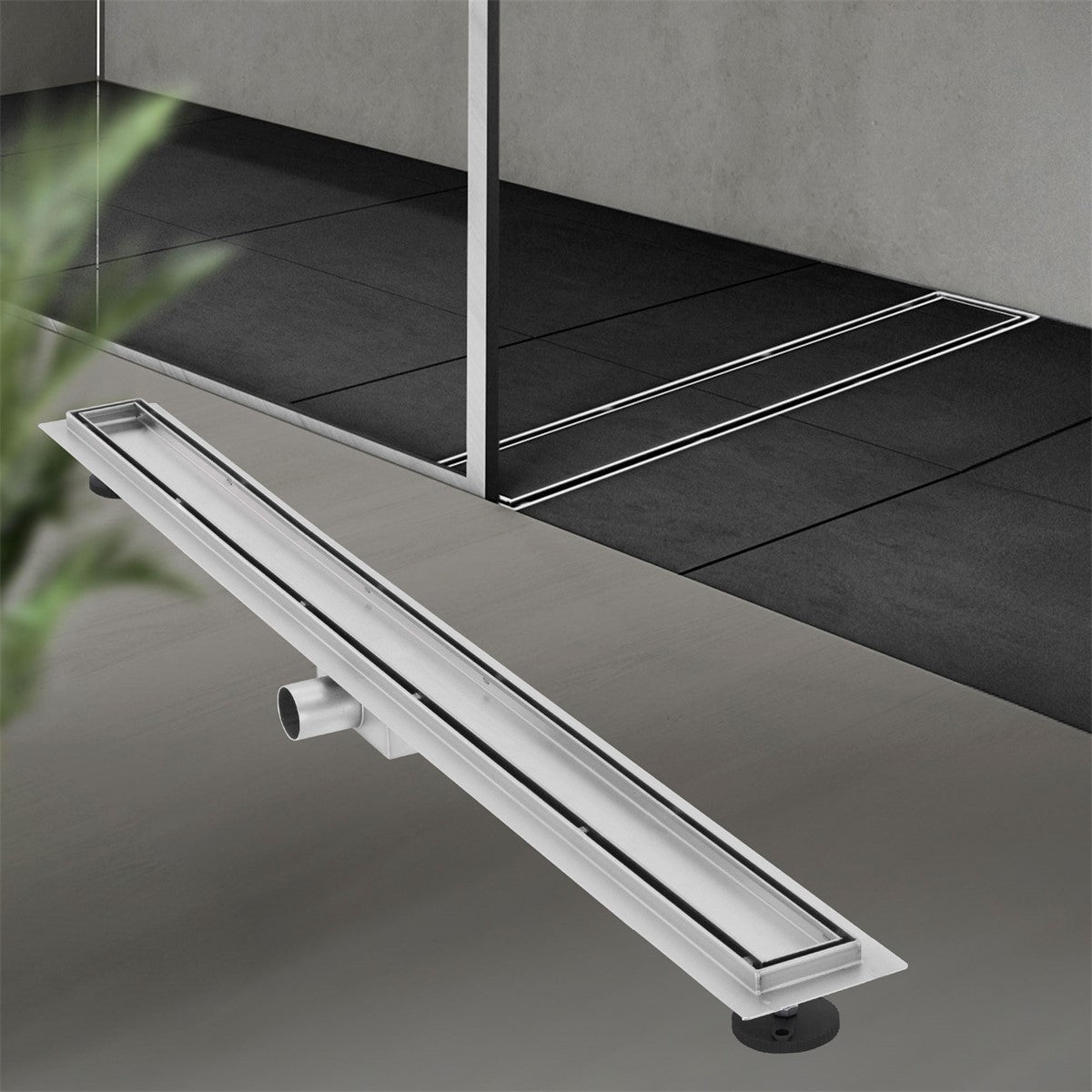 Long shower drain in a modern bathroom with gray tiles.