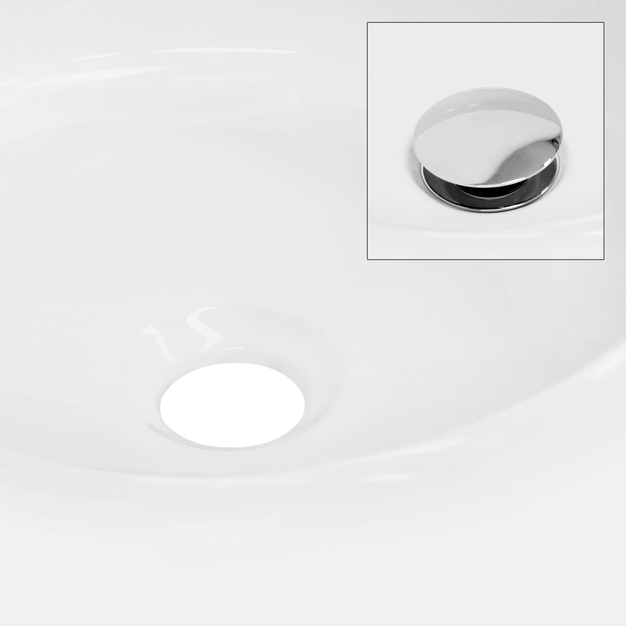 Close-up of the drain of a white sink with a shiny cover.