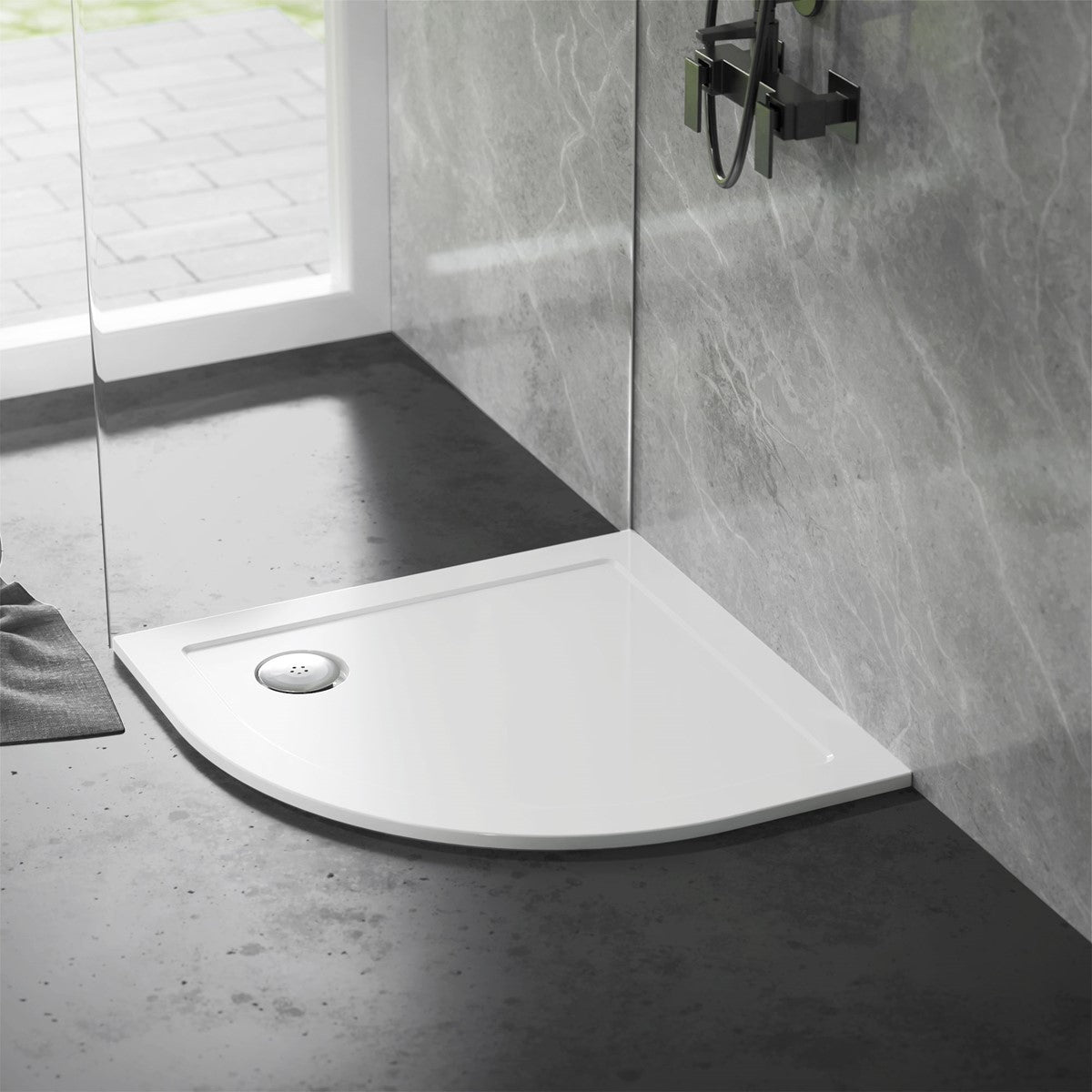Shower tray in a modern bathroom setting with gray walls.