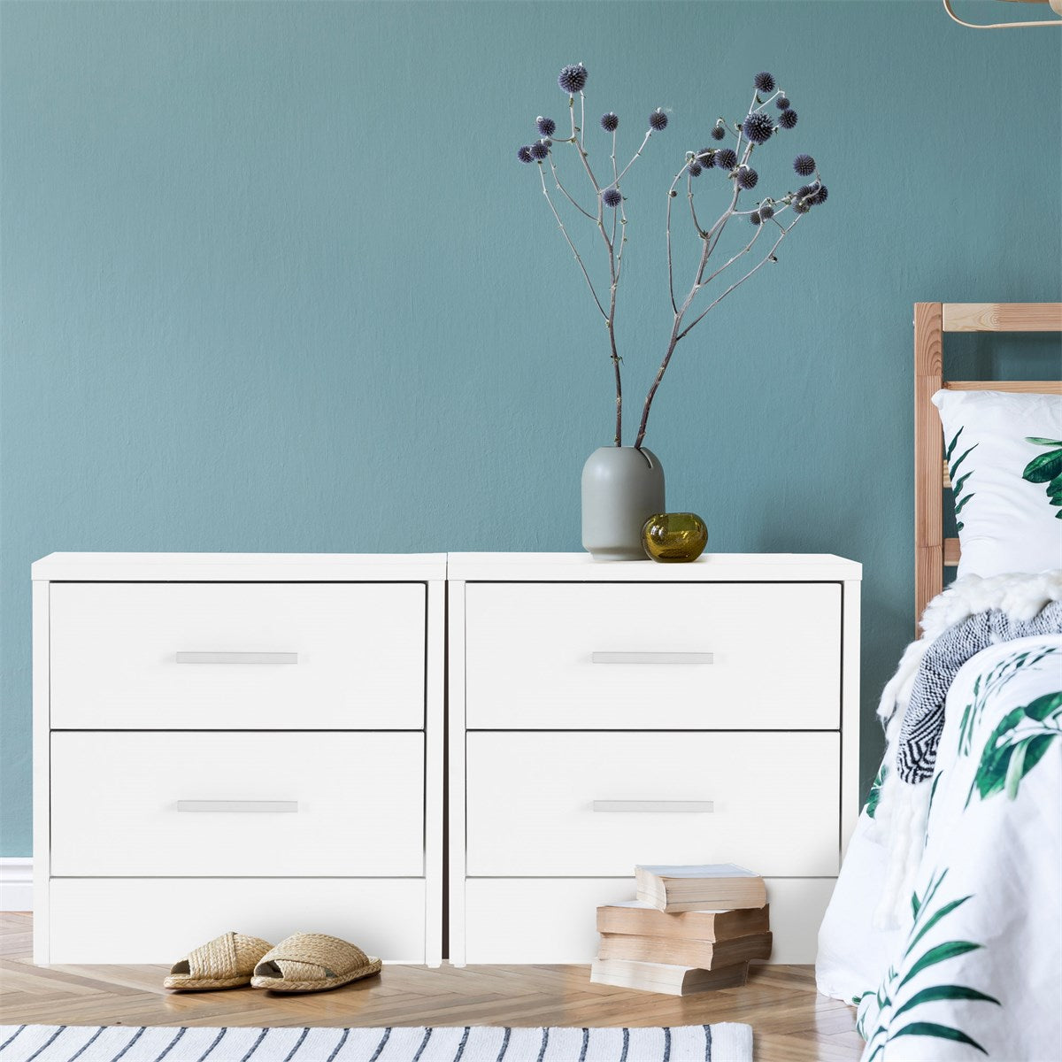 White chest of drawers with two drawers and a vase on the surface.