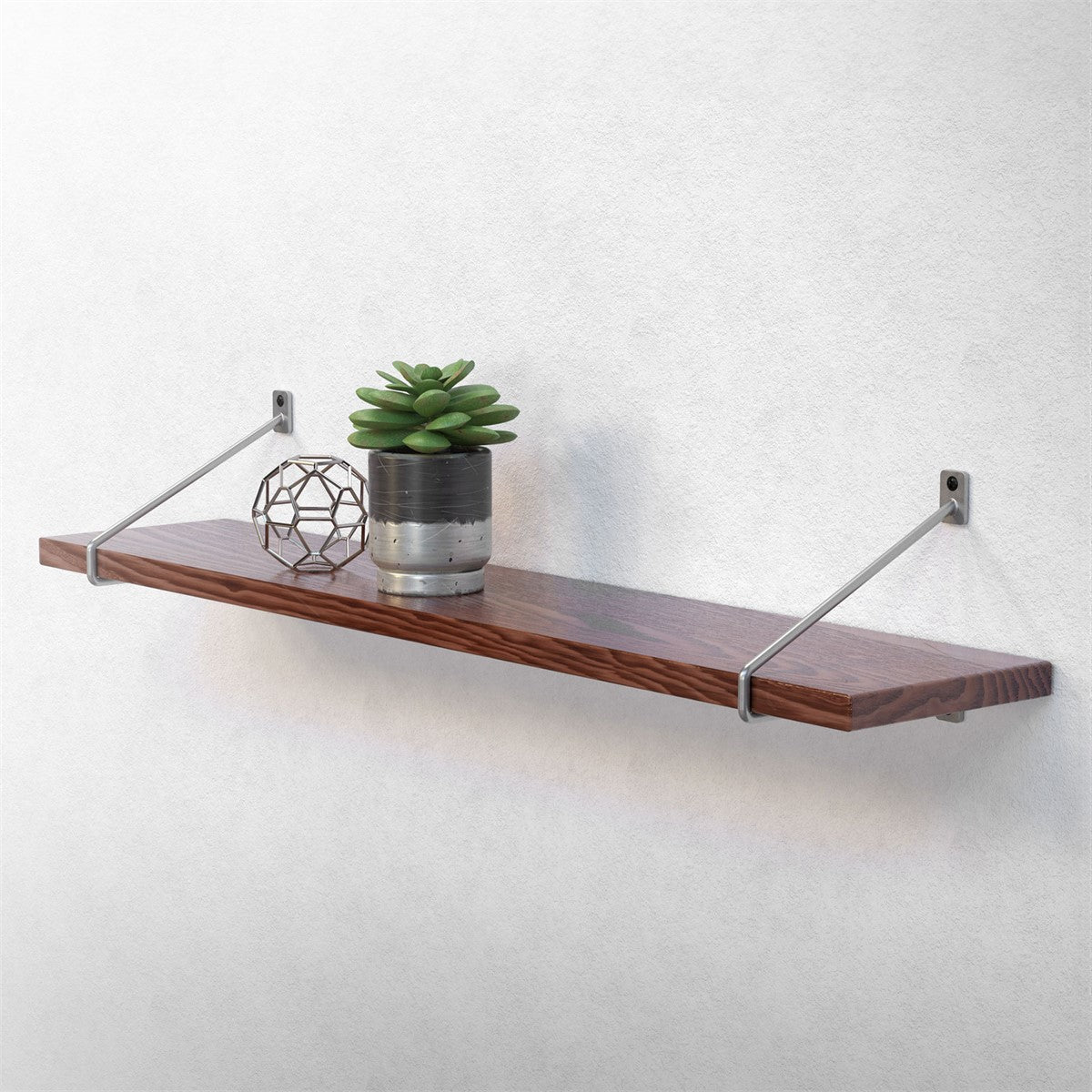 Wooden shelf with a plant and a decorative sphere.