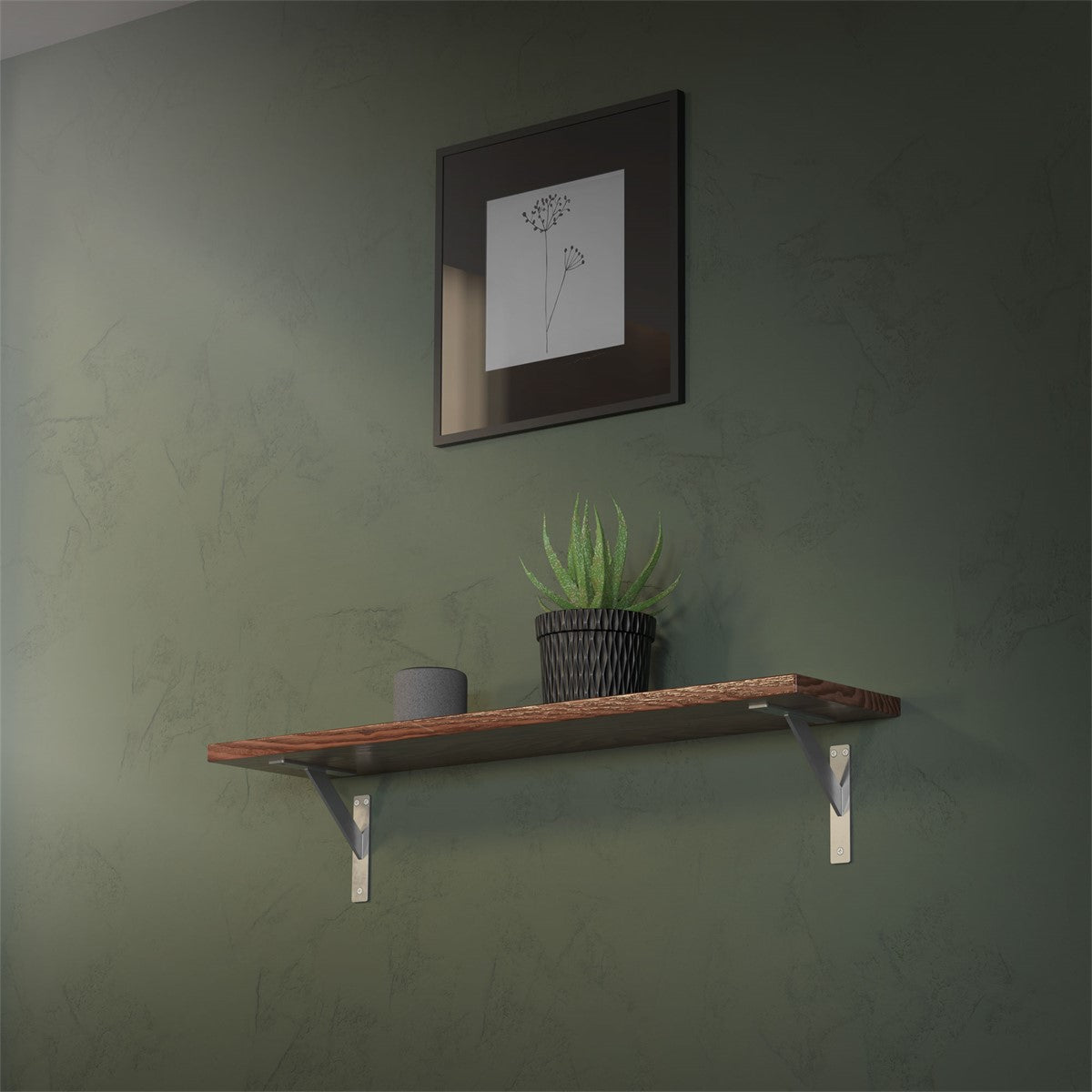 Wooden shelf on a green wall with a plant and a framed picture.