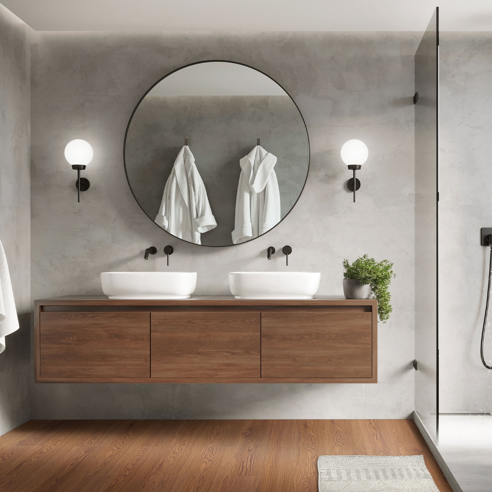 Modernes Badezimmer mit Doppelwaschbecken und runder Spiegel.