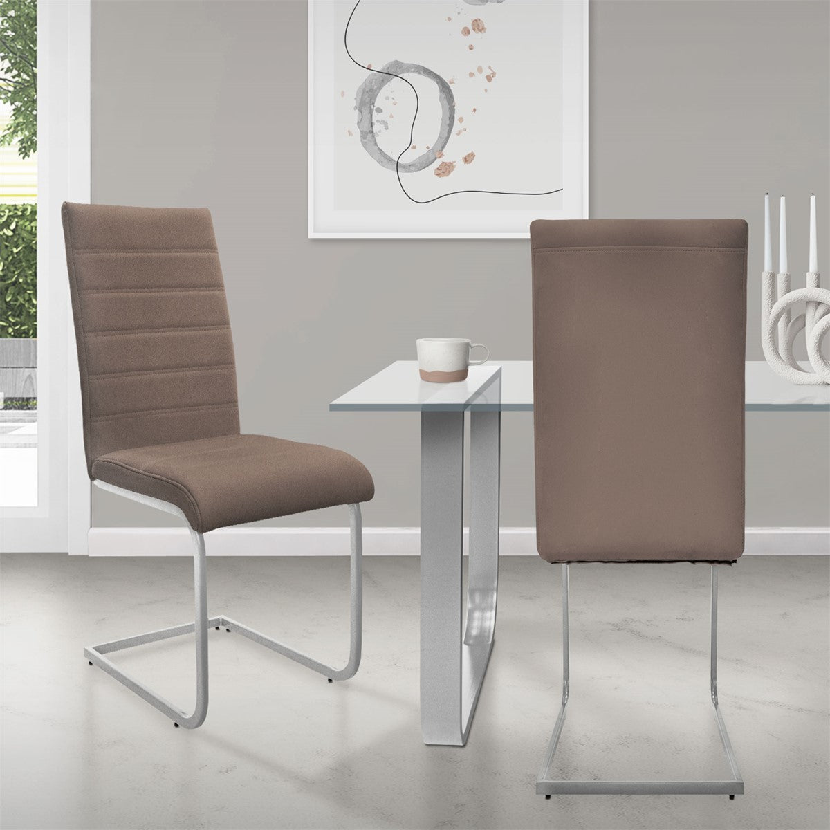 Two brown chairs at a table with a glass top in a modern room.