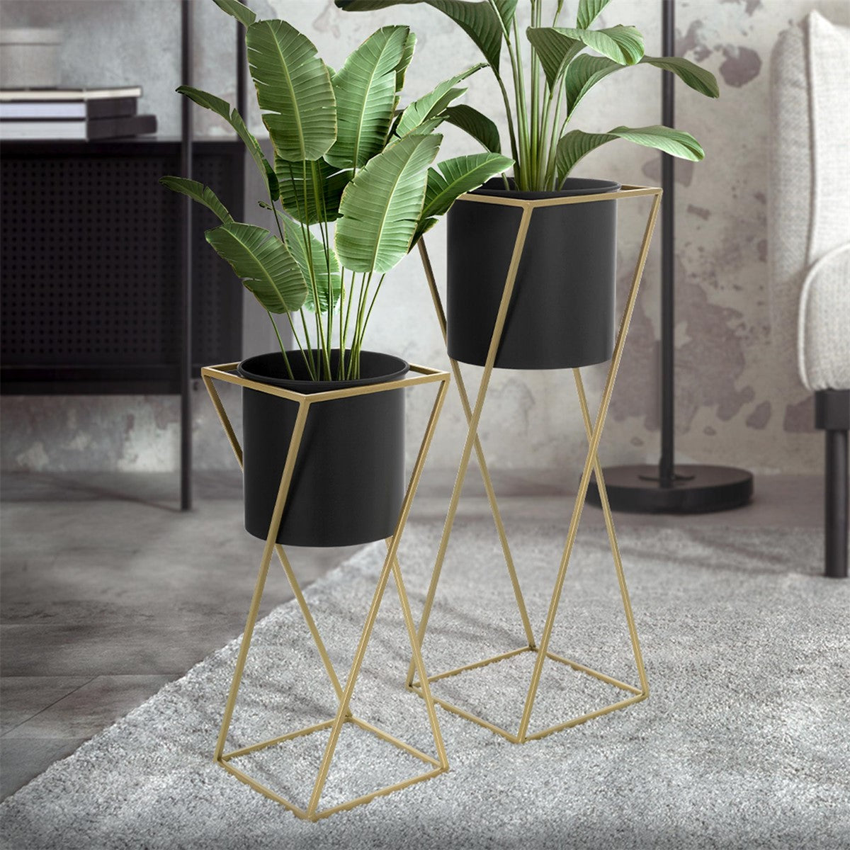Two plant stands with plants in a modern room on a rug.