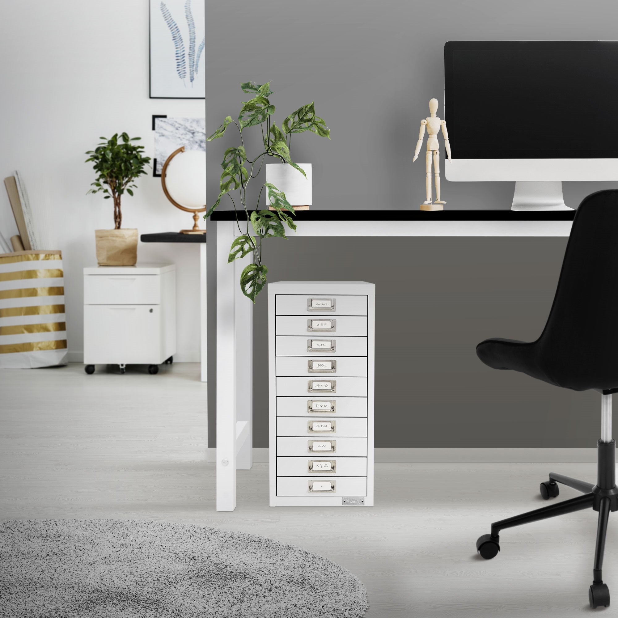 Weißer Aktenschrank unter einem Schreibtisch in einem modernen Büro.