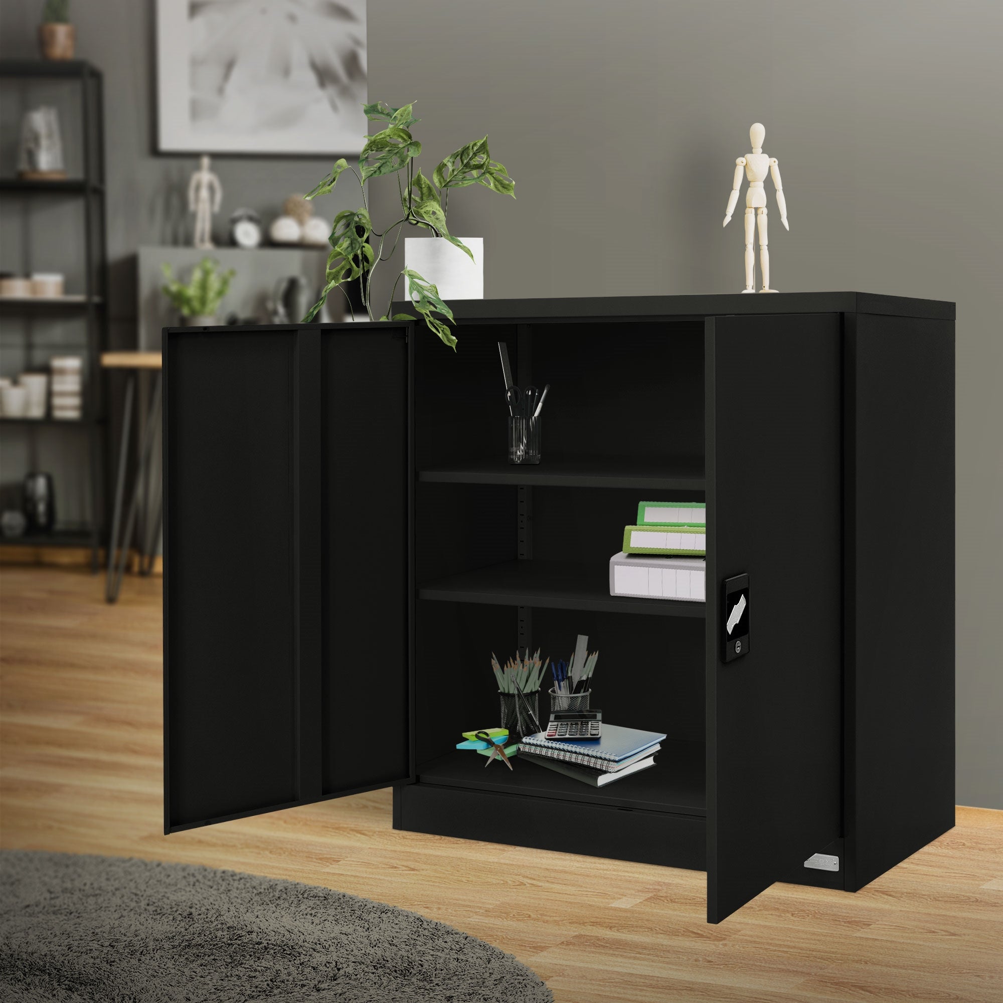 Schwarzer Schrank in einem Raum mit Pflanzen und einem Holzfußboden.