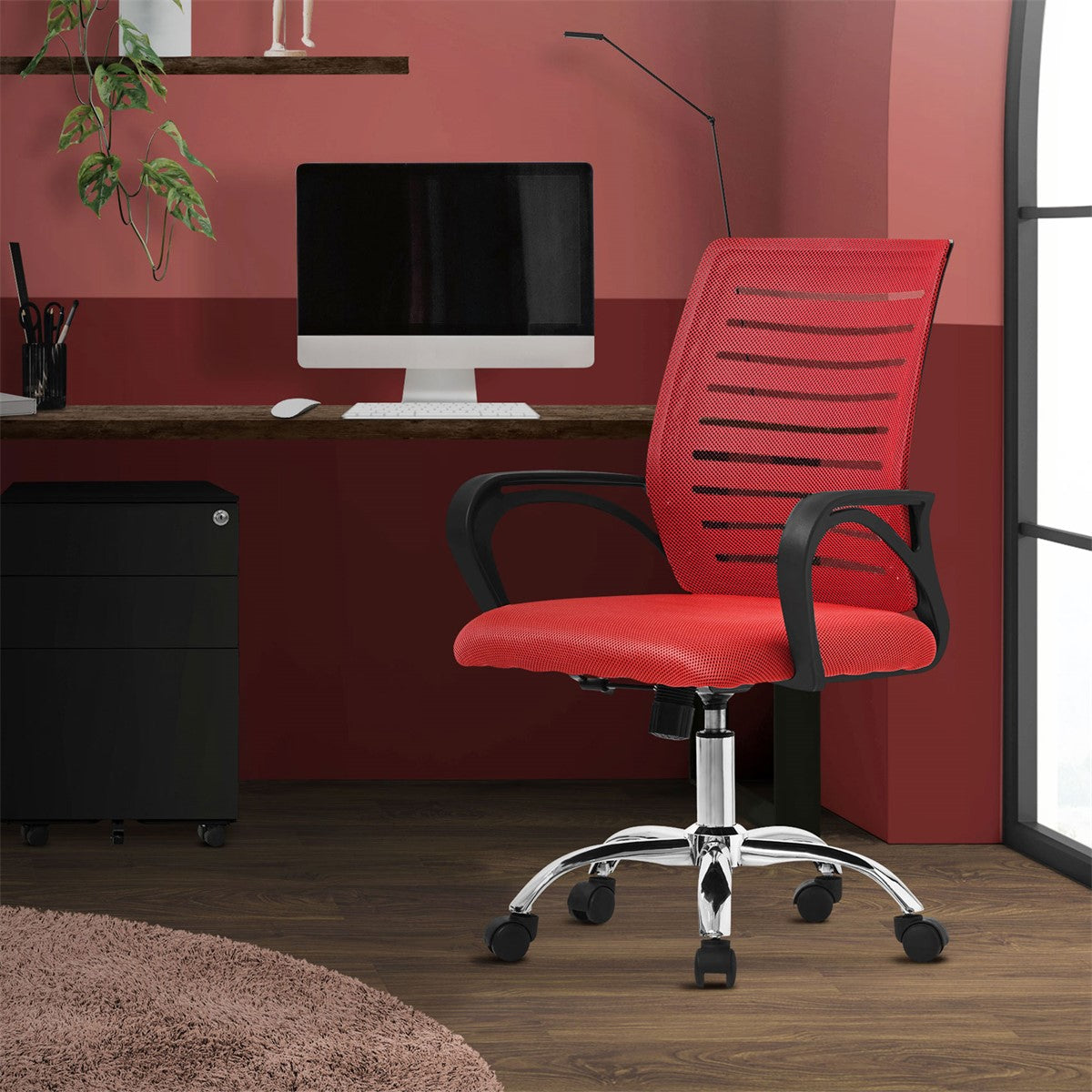 Red office chair in front of a desk in a red room.