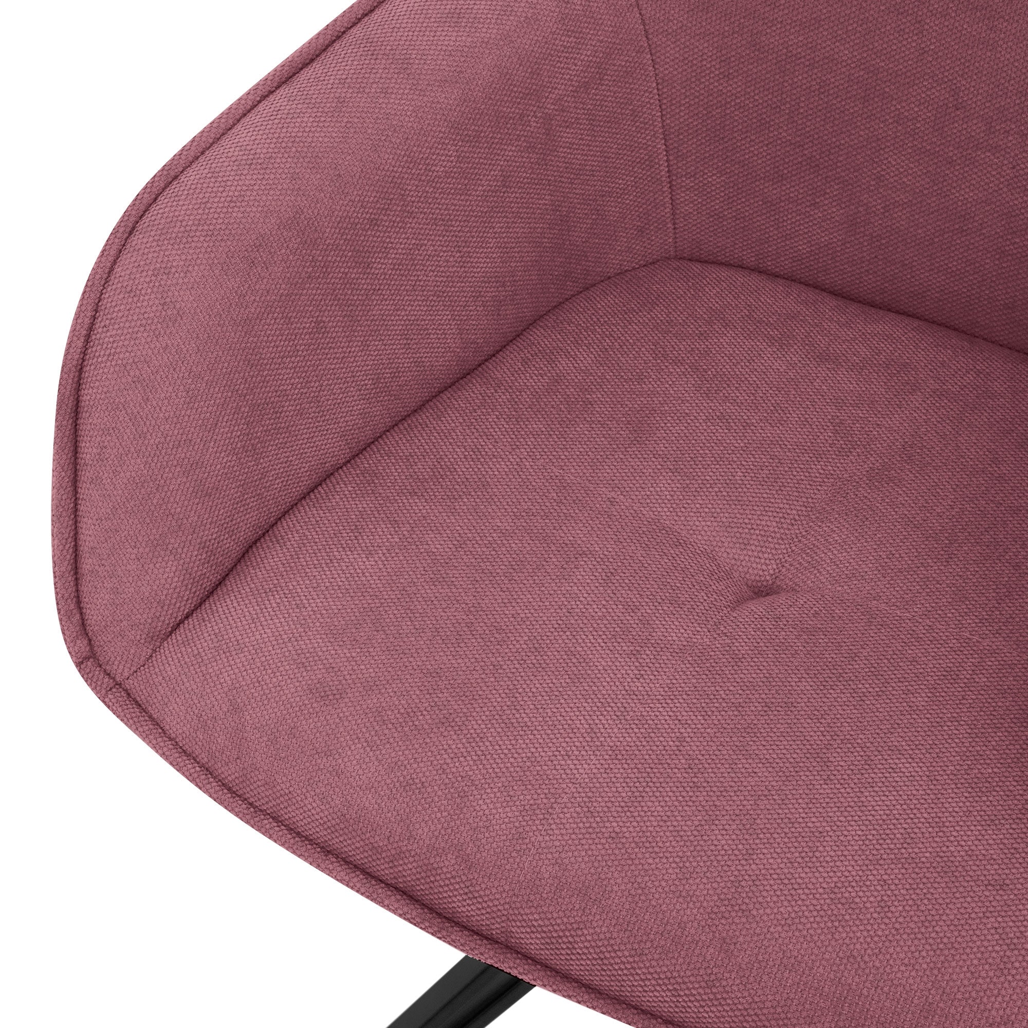 Close-up of a pink upholstered chair with a button detail.