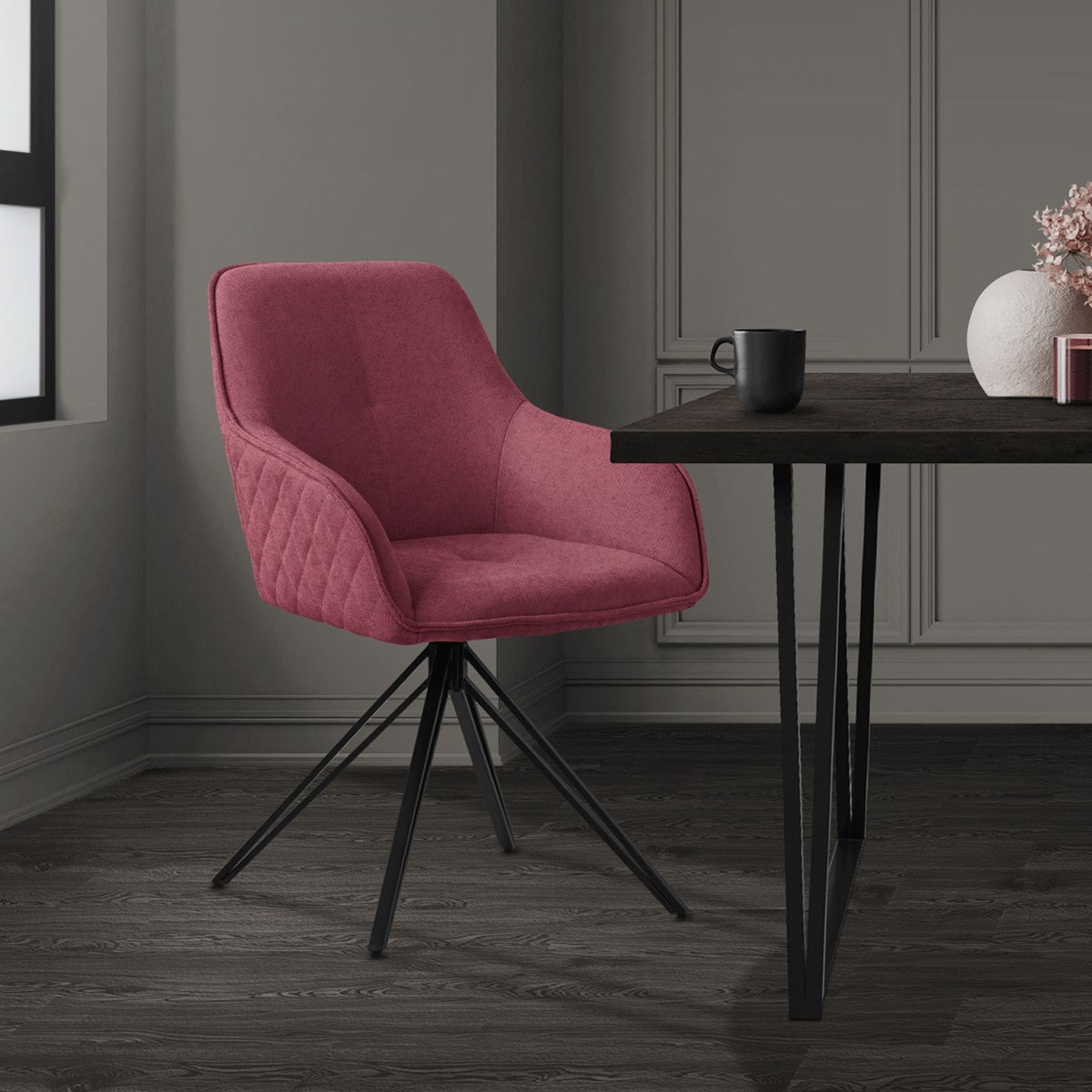 Pink chair at a table in a room with plants and decorations.