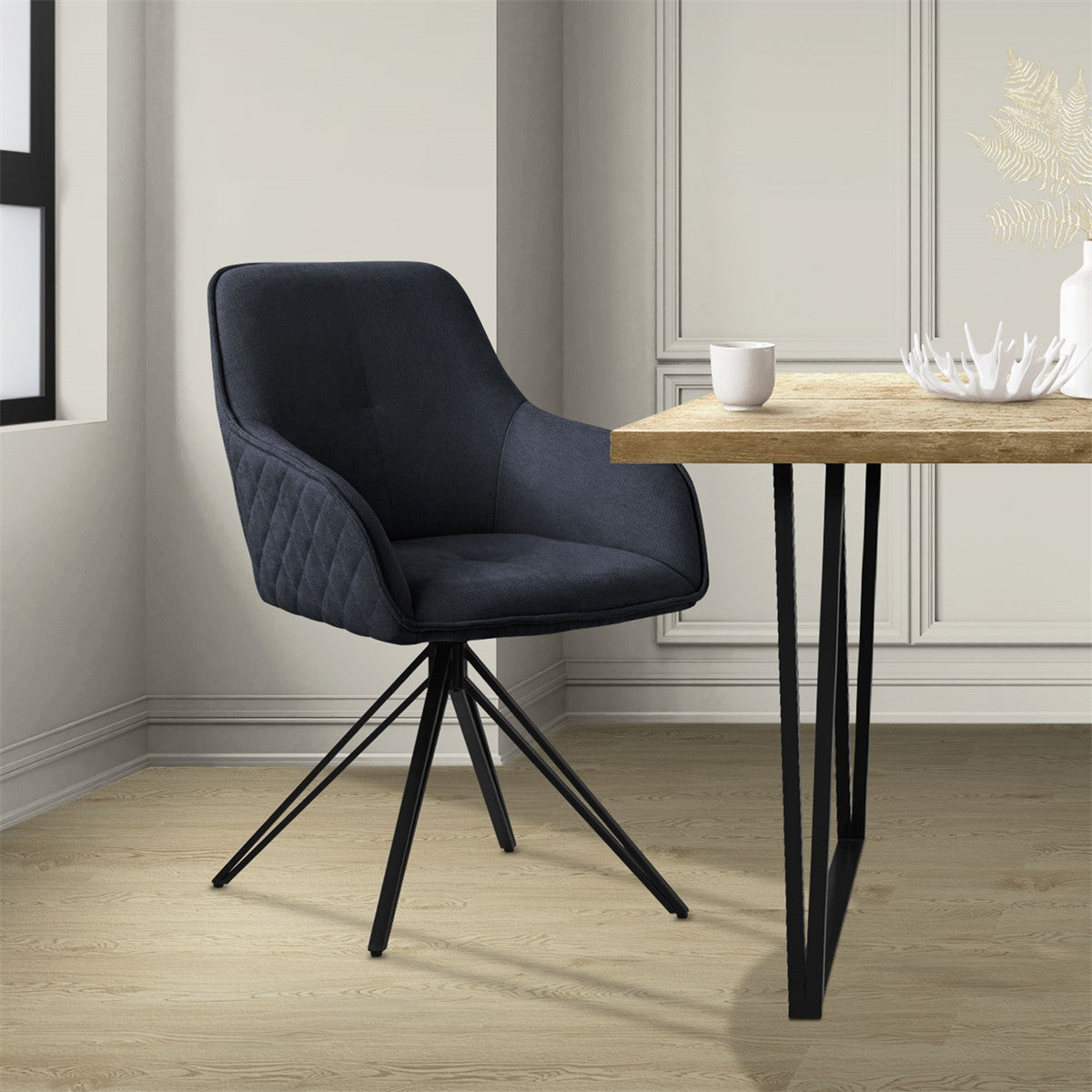 A black chair with a table in a bright room.