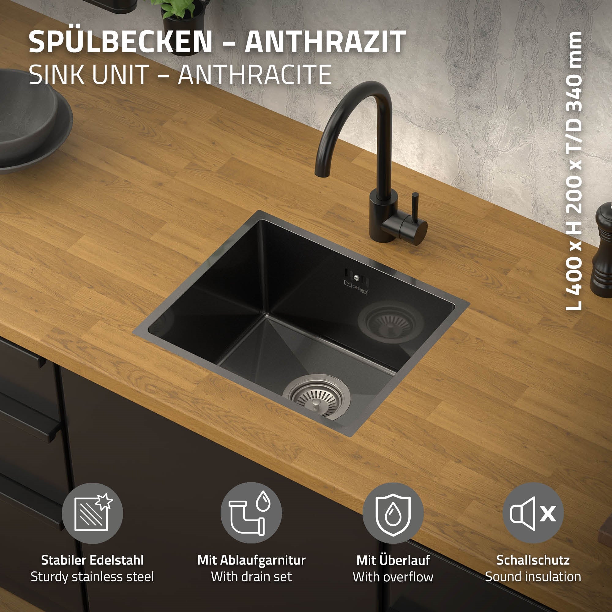 Anthrazitfarbene Spüle mit Wasserhahn auf Holzoberfläche.