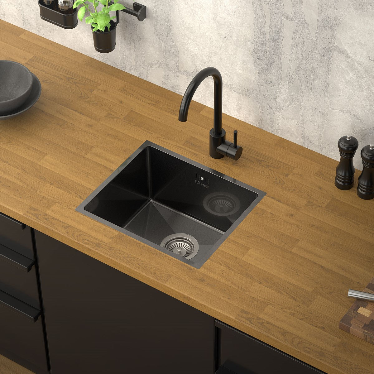 Black sink in a wooden worktop with two drains.