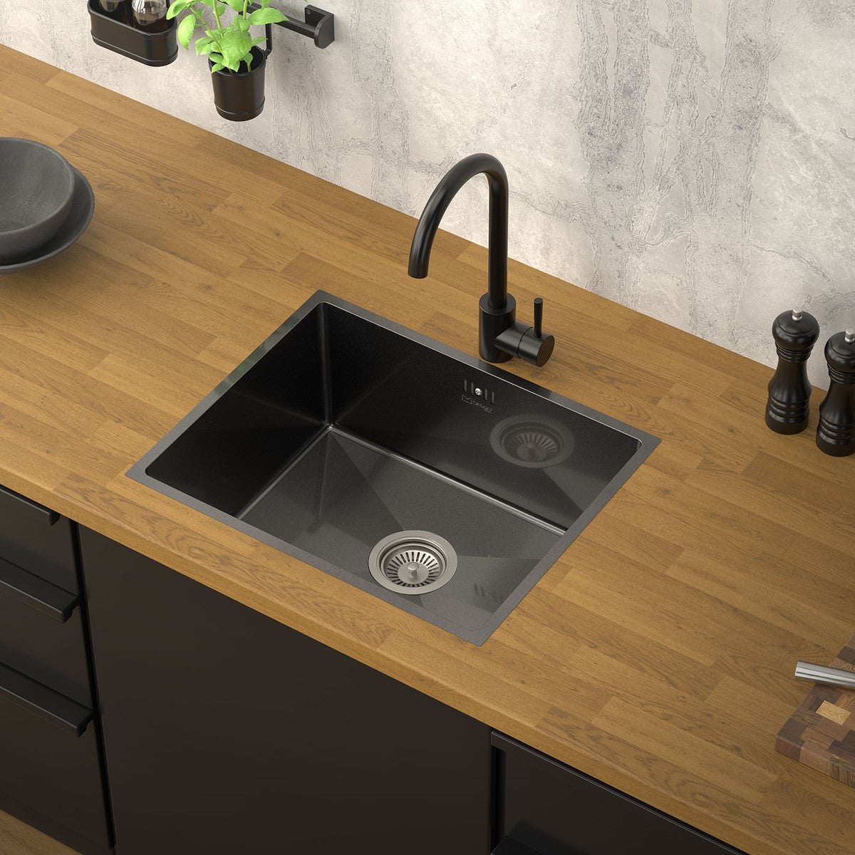 Black sink on a wooden countertop with a faucet and zu
