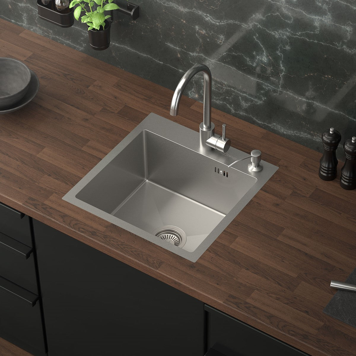 Kitchen sink with faucet on a wooden countertop.