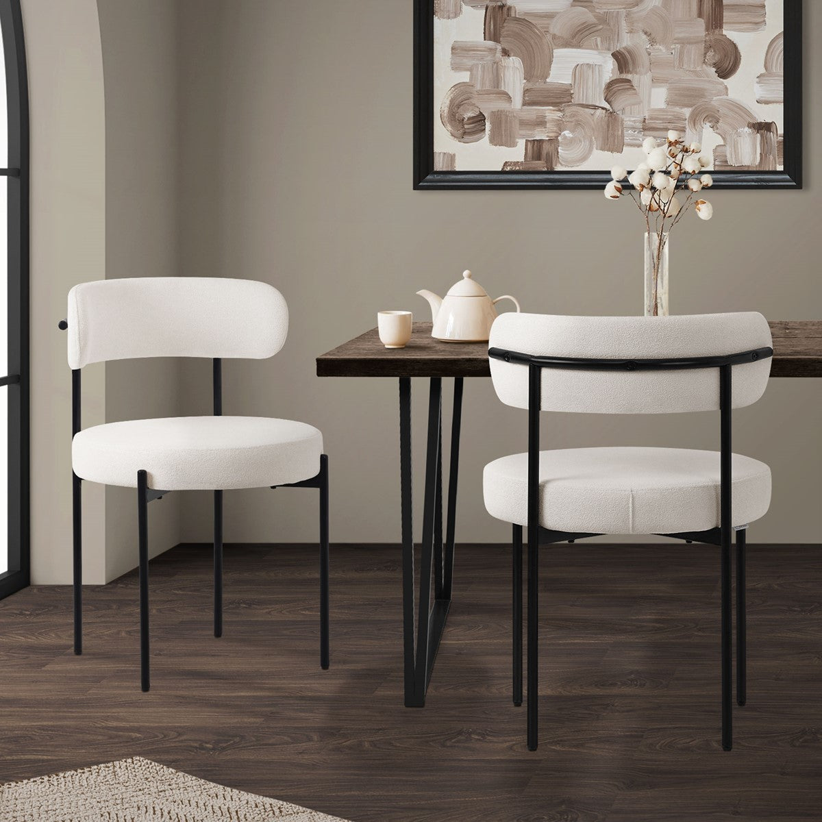 Dining area with two white chairs and a table.