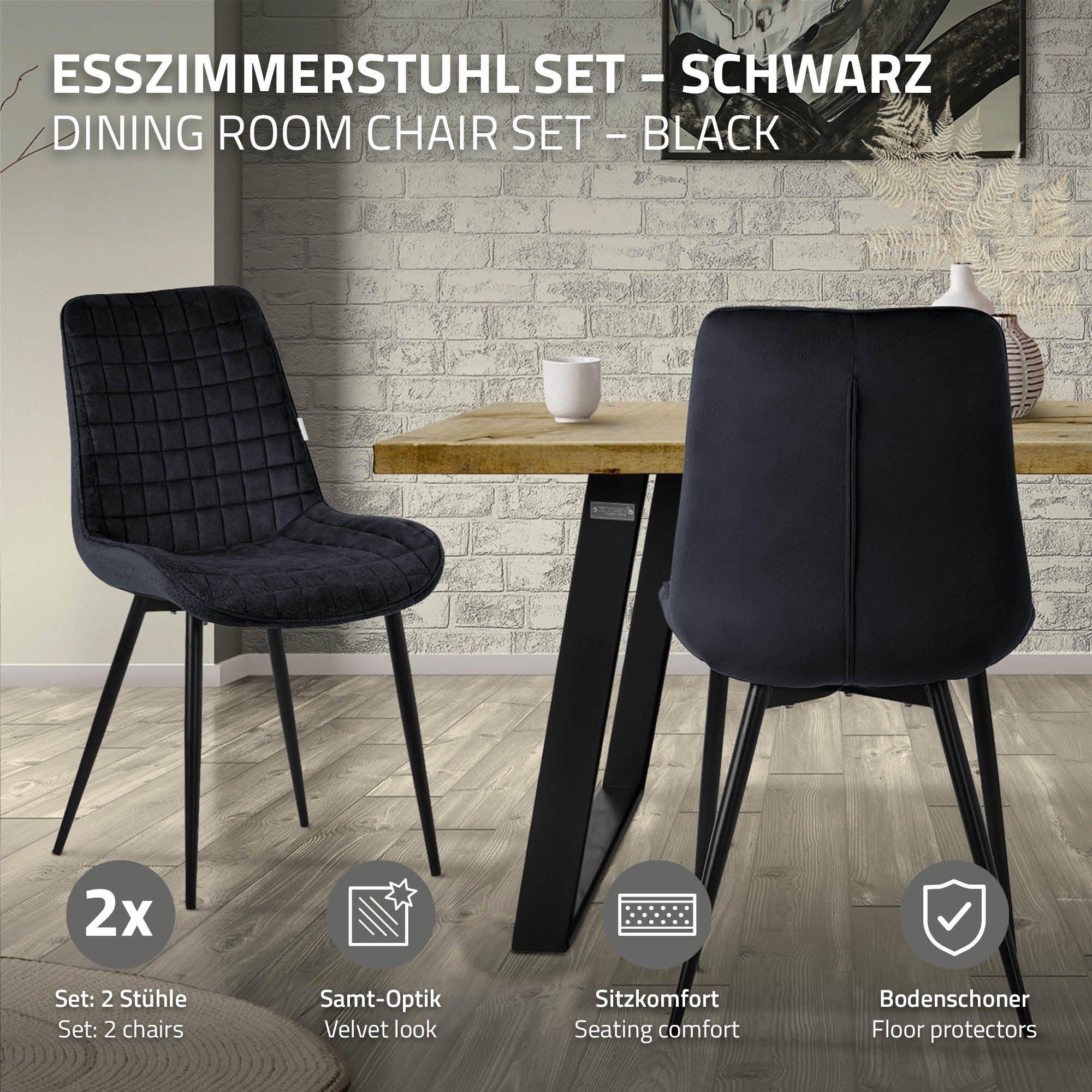 Zwei schwarze Stühle an einem Tisch in einem modernen Raum mit grauer Wand.