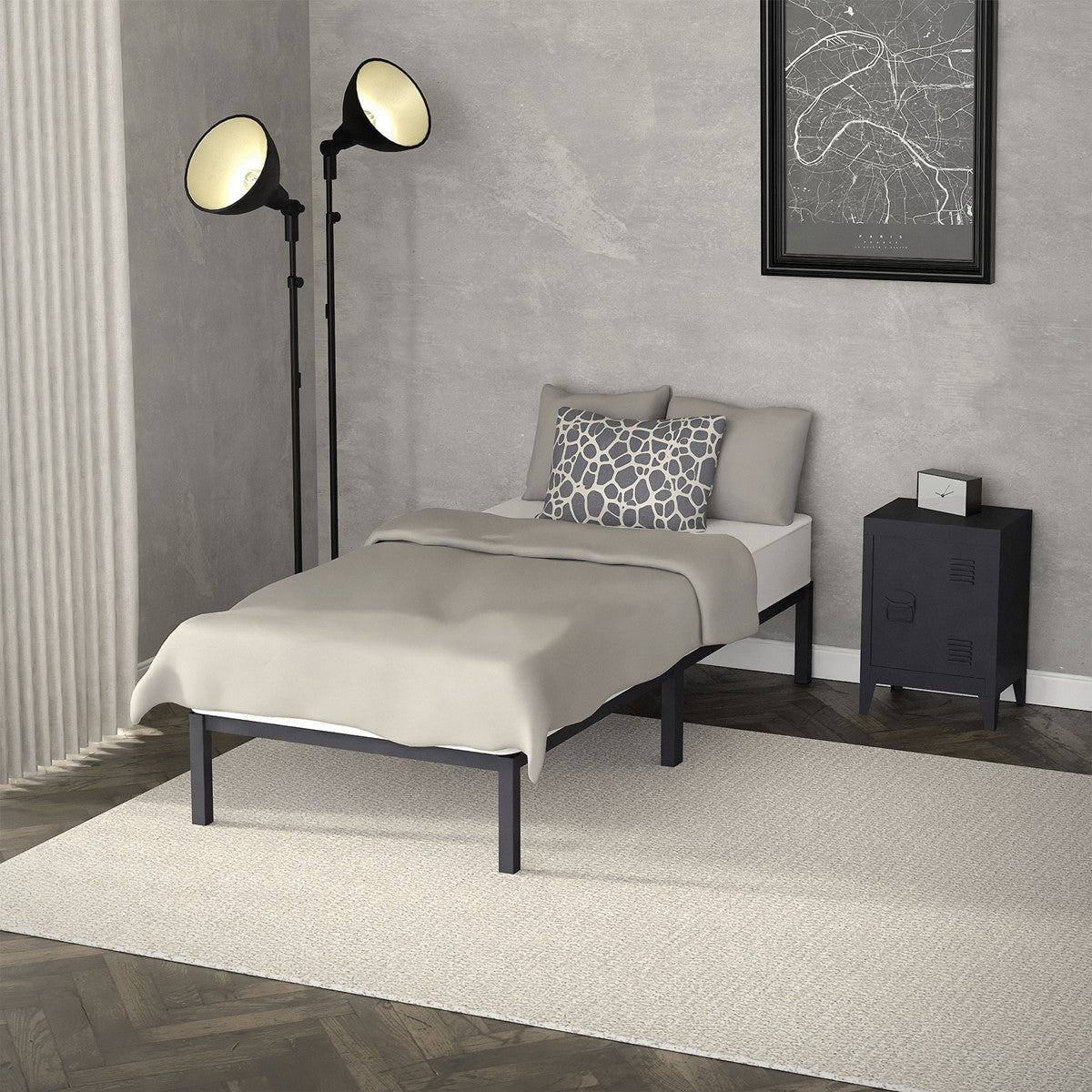 Single bed with a gray blanket and pillow beside a black bedside table and floor lamp in a gray-decorated room.