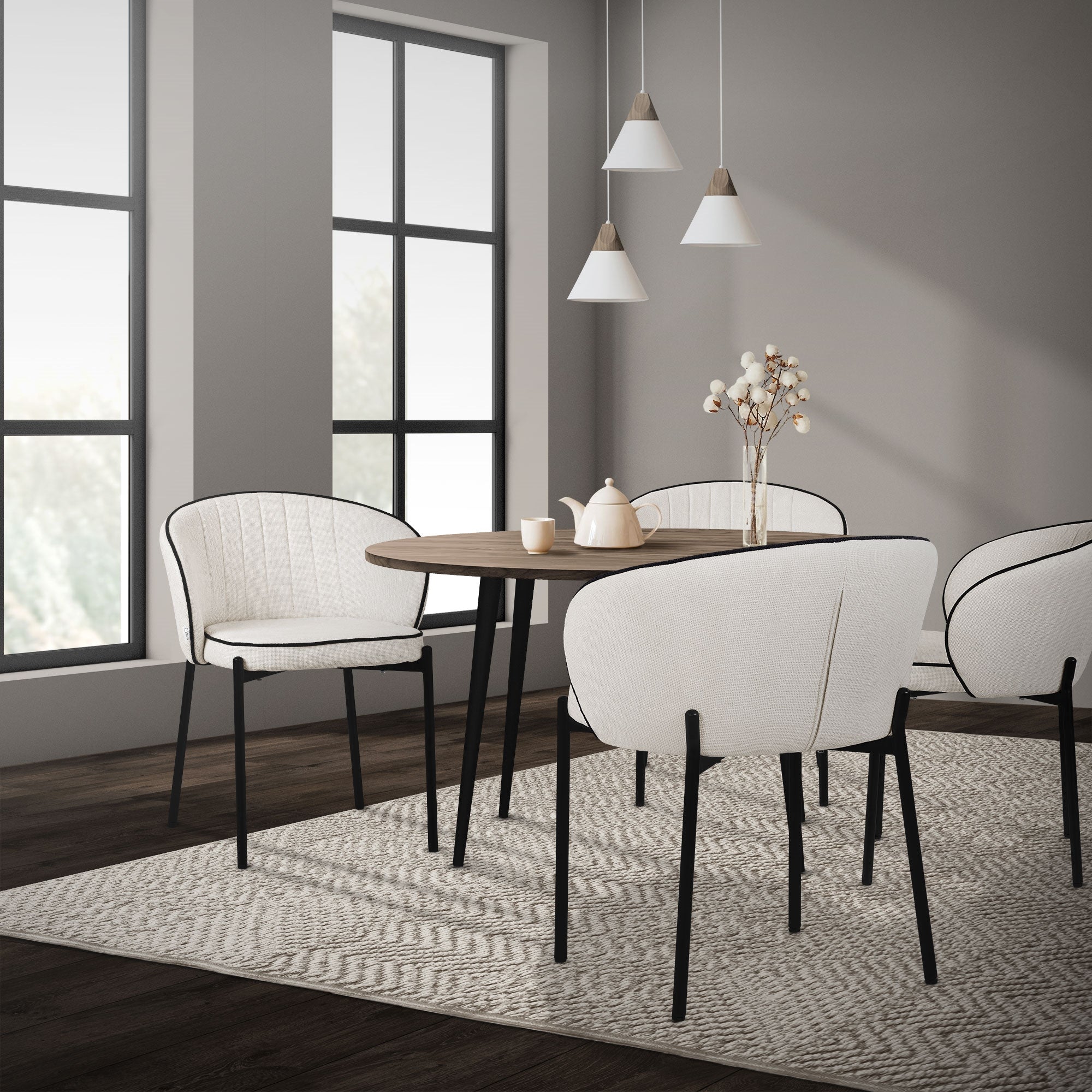 Bright dining area with white chairs and a round table.