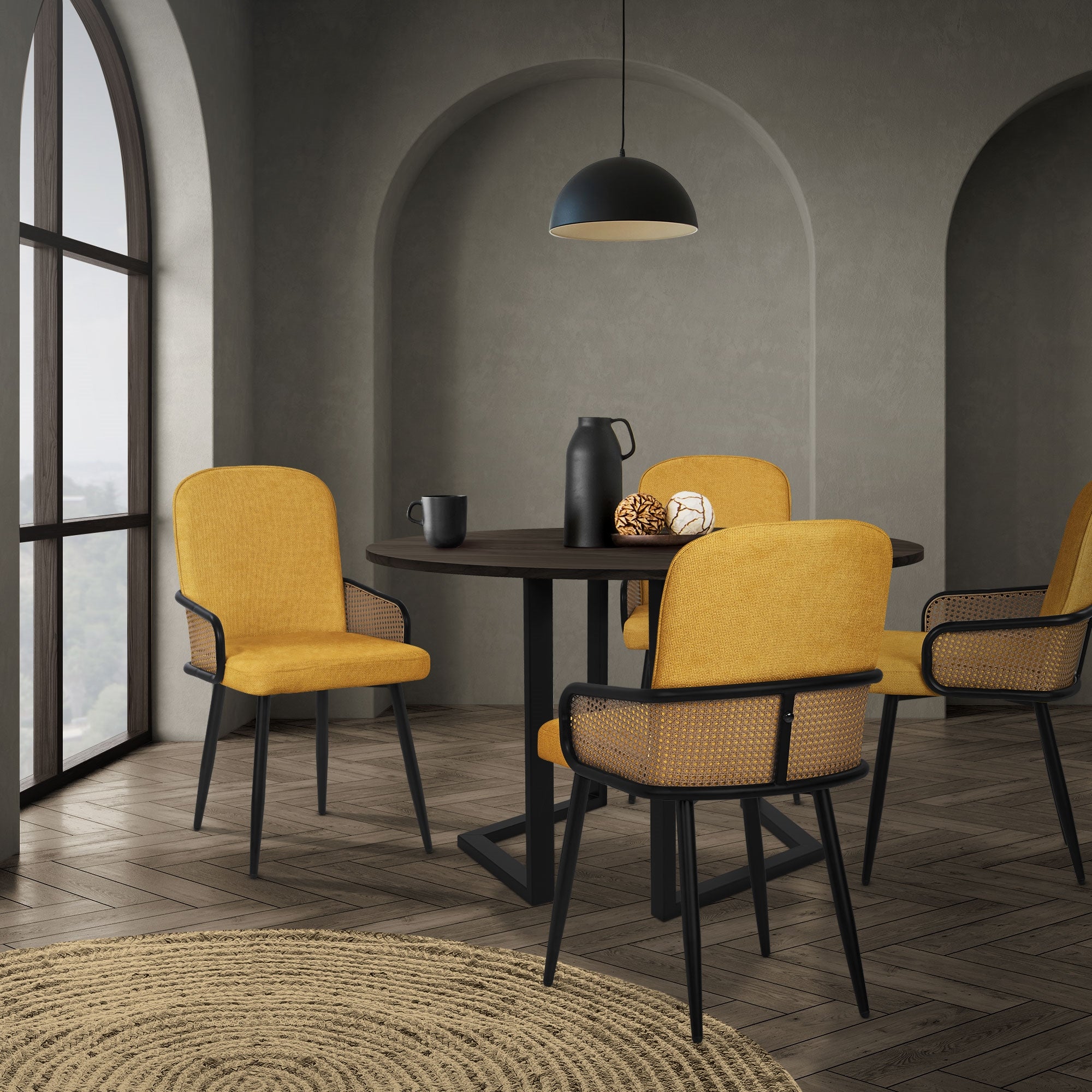Dining room with a round table and four yellow chairs in a modern room.