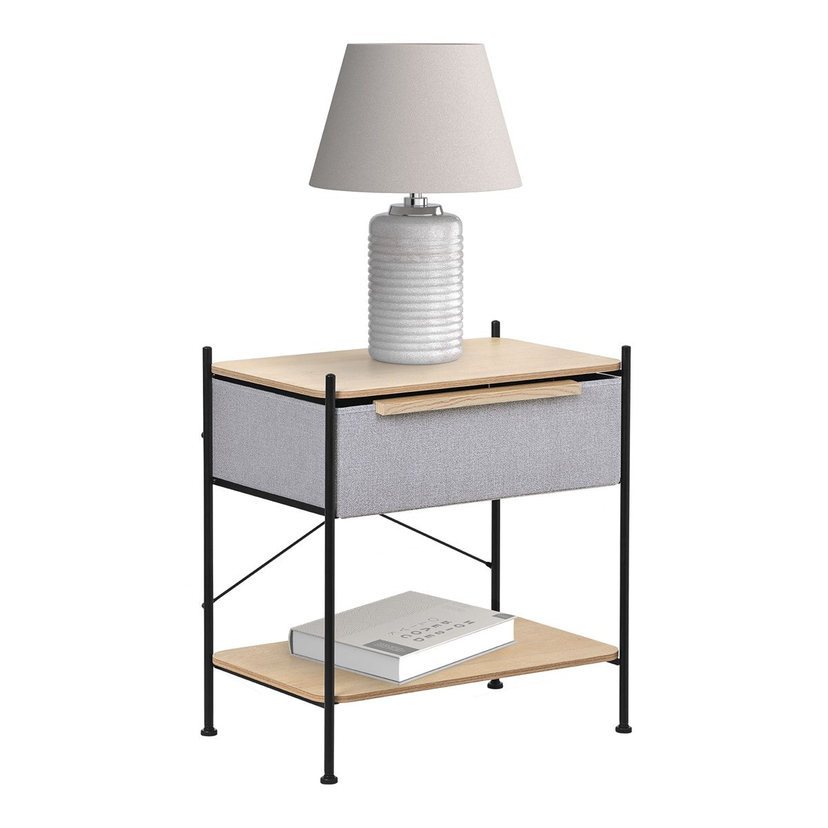Bedside table with a lamp, drawer and book on the shelf.