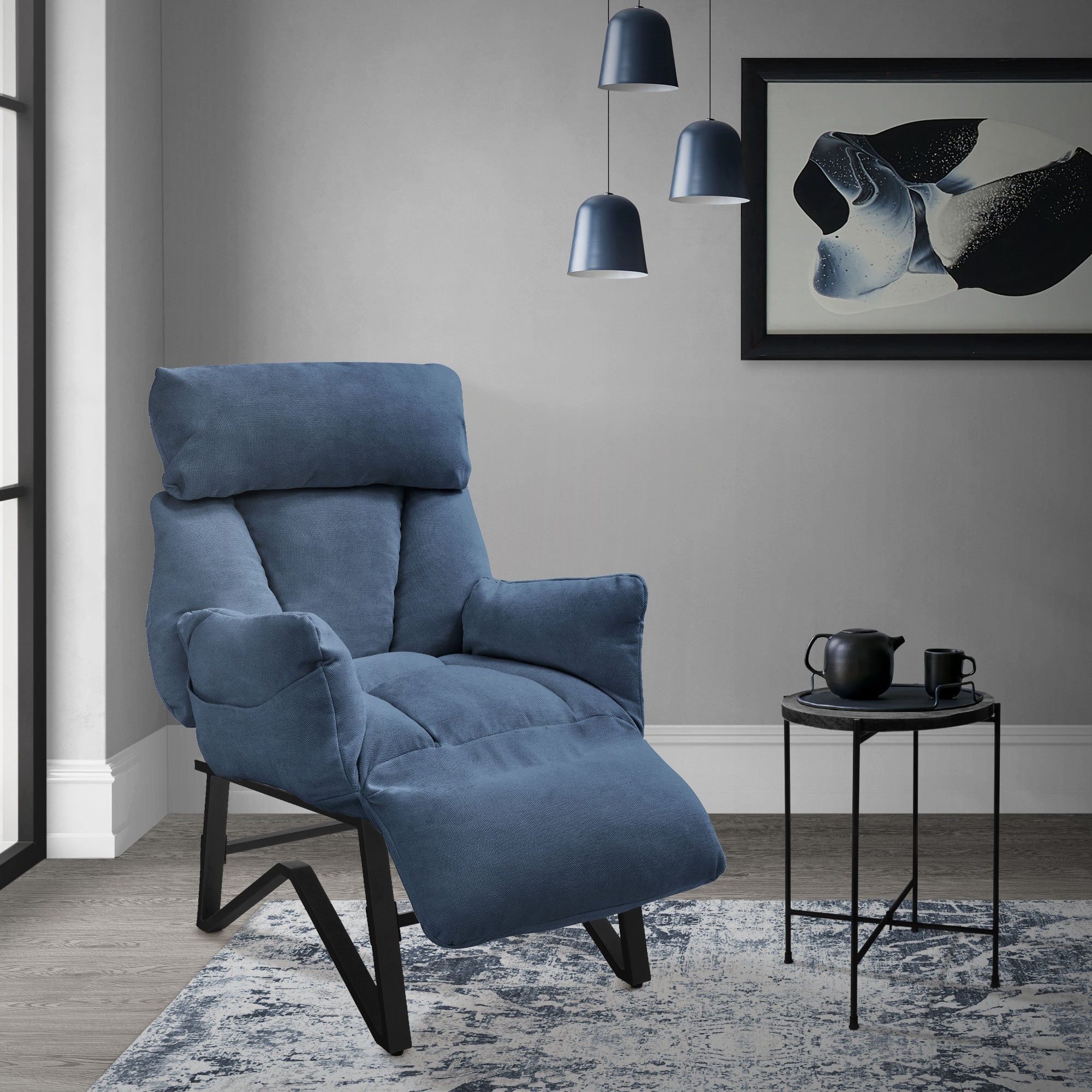 Blue reclining armchair in a modern room with a table and decoration.