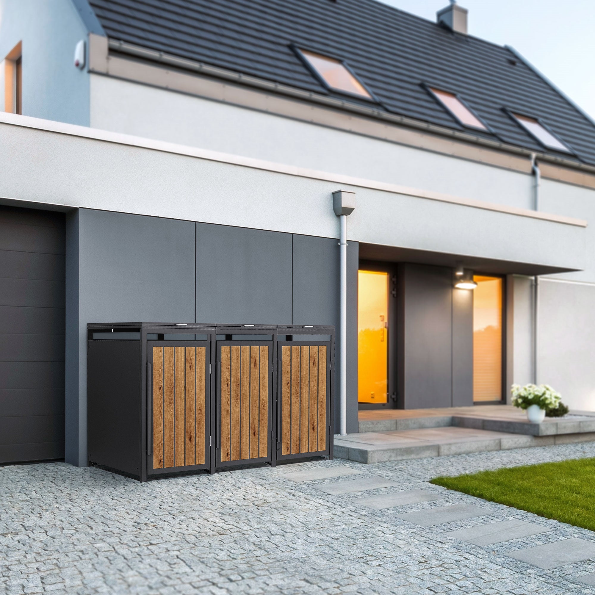 Mülltonnen in einem modernen Außenbereich vor einem Haus.