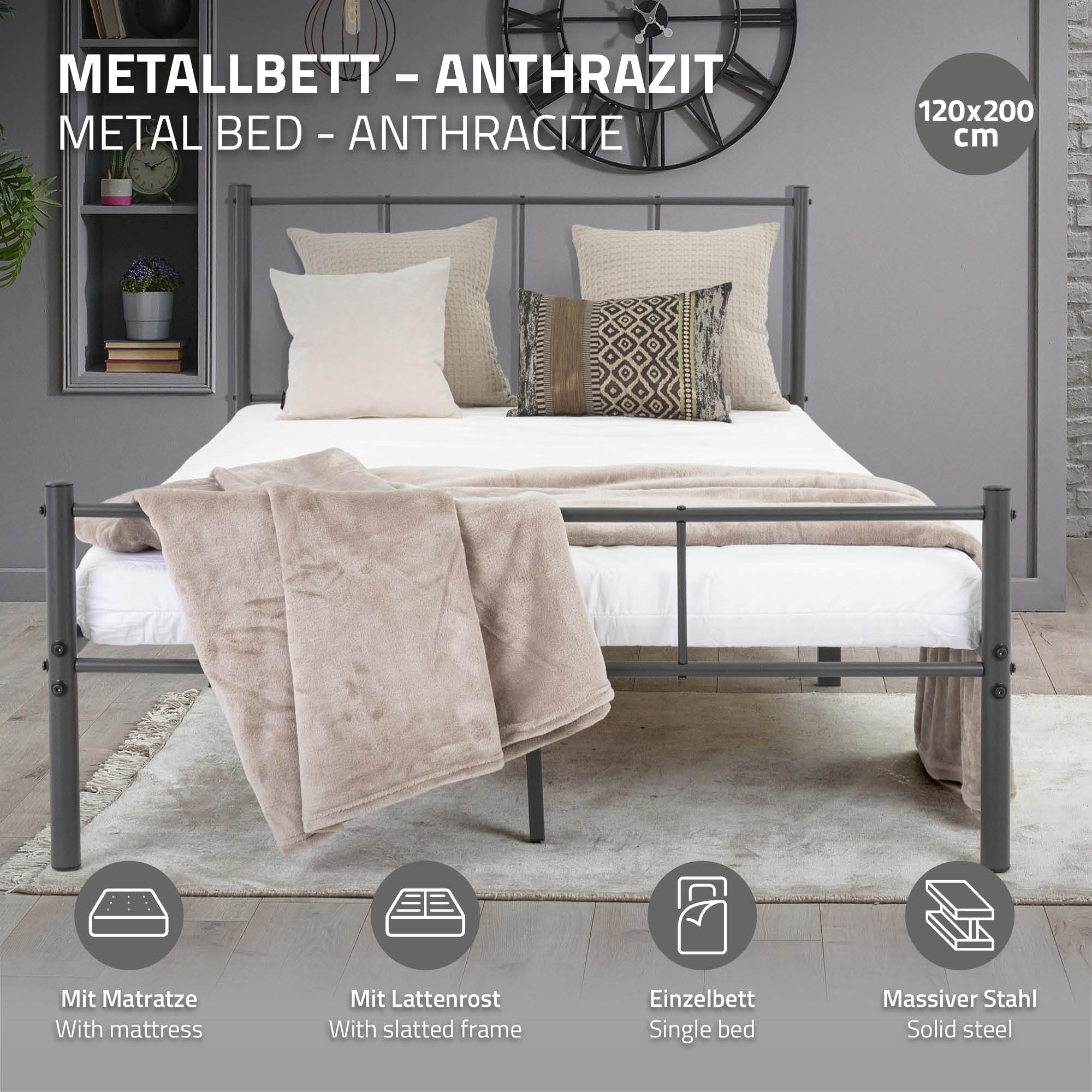 Metallbett in Anthrazit mit Kissen und Decke.