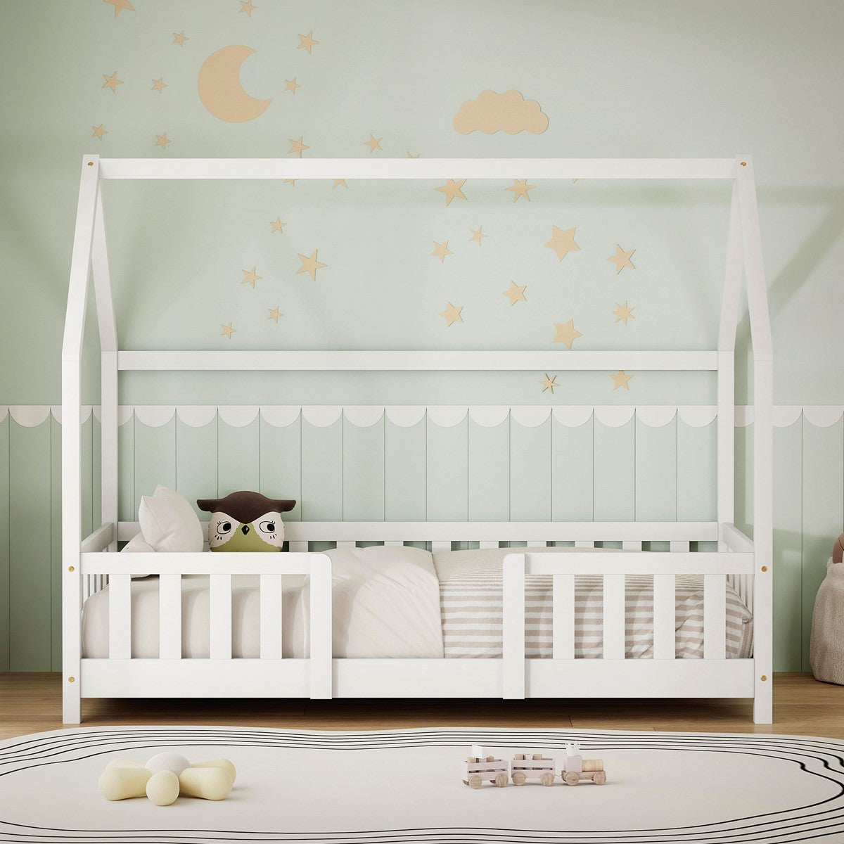 A white bed with pillows and a blanket in a children's room.