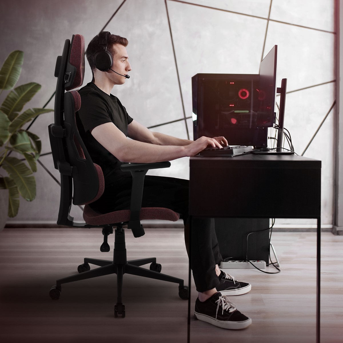 Persona con cuffie alla scrivania con un PC da gaming.
