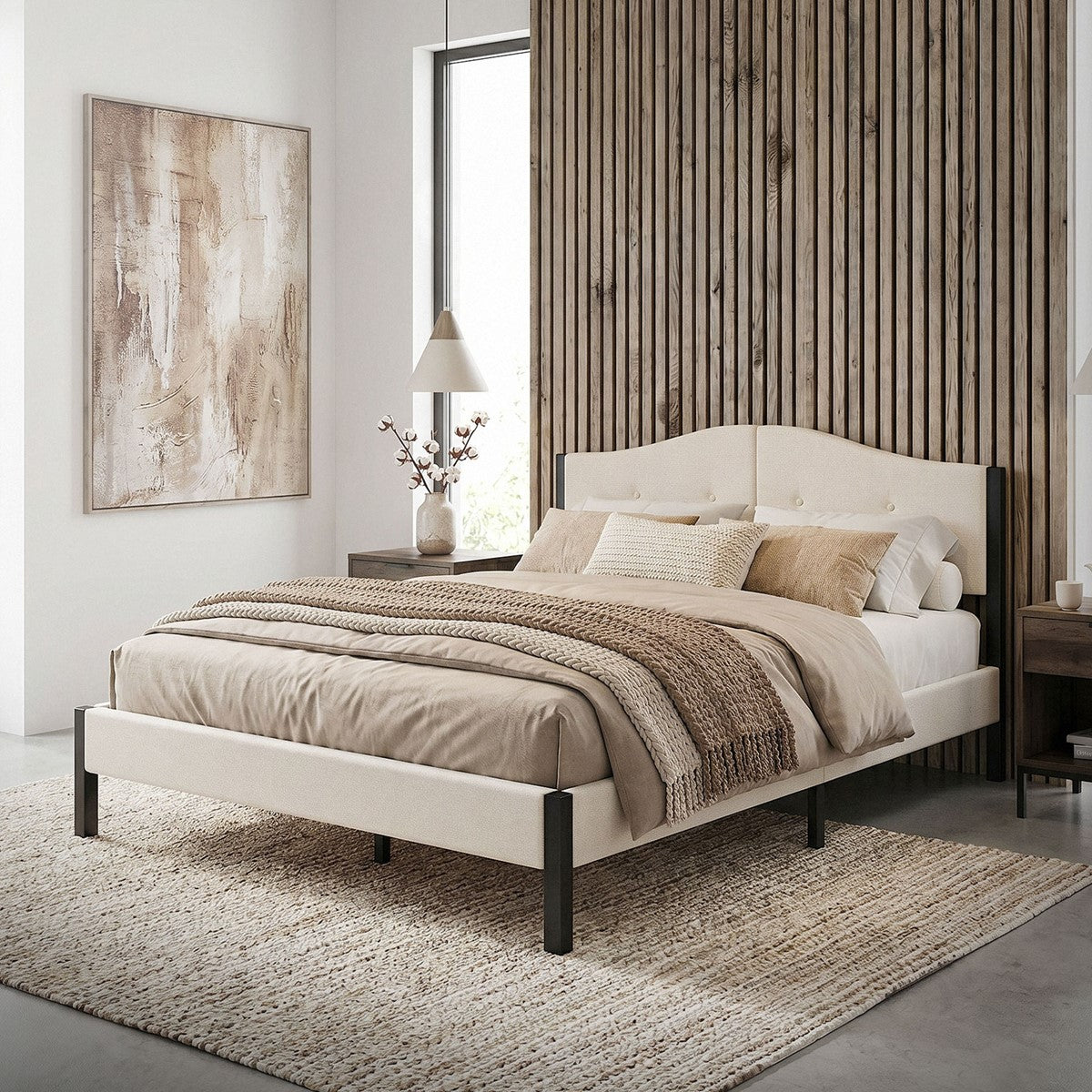Bed in a modern room with wood panelling and decorative cushions.