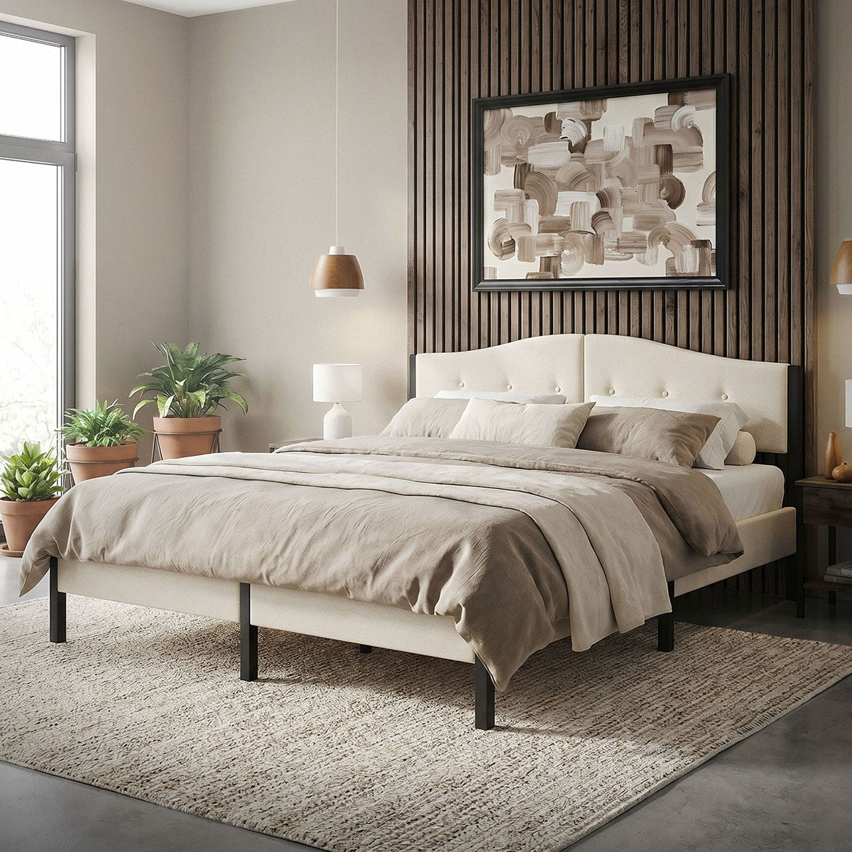 A bedroom with a beige bed, plants, and a work of art on the wall.
