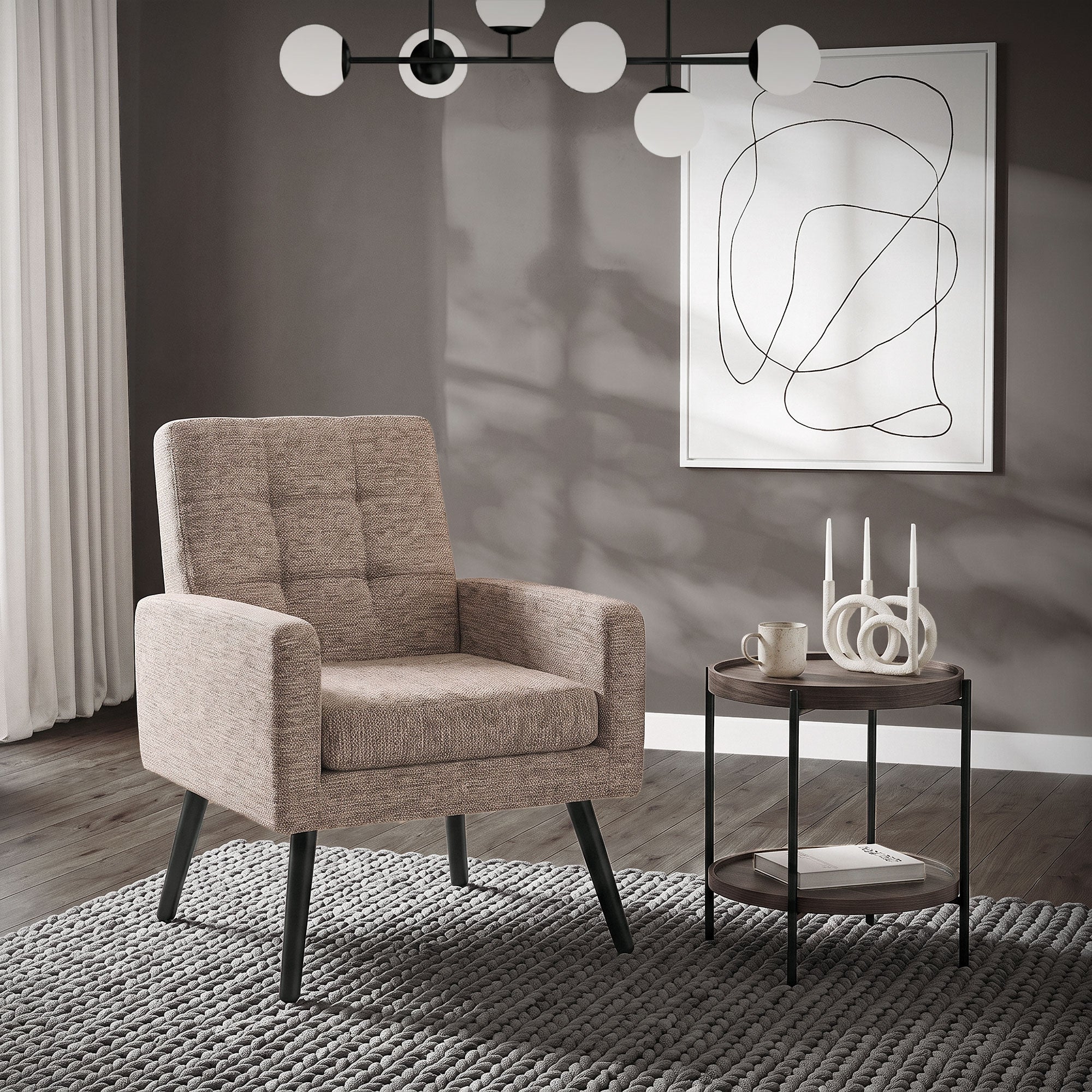 Beige armchair with square upholstery, table, and wall art in the background.