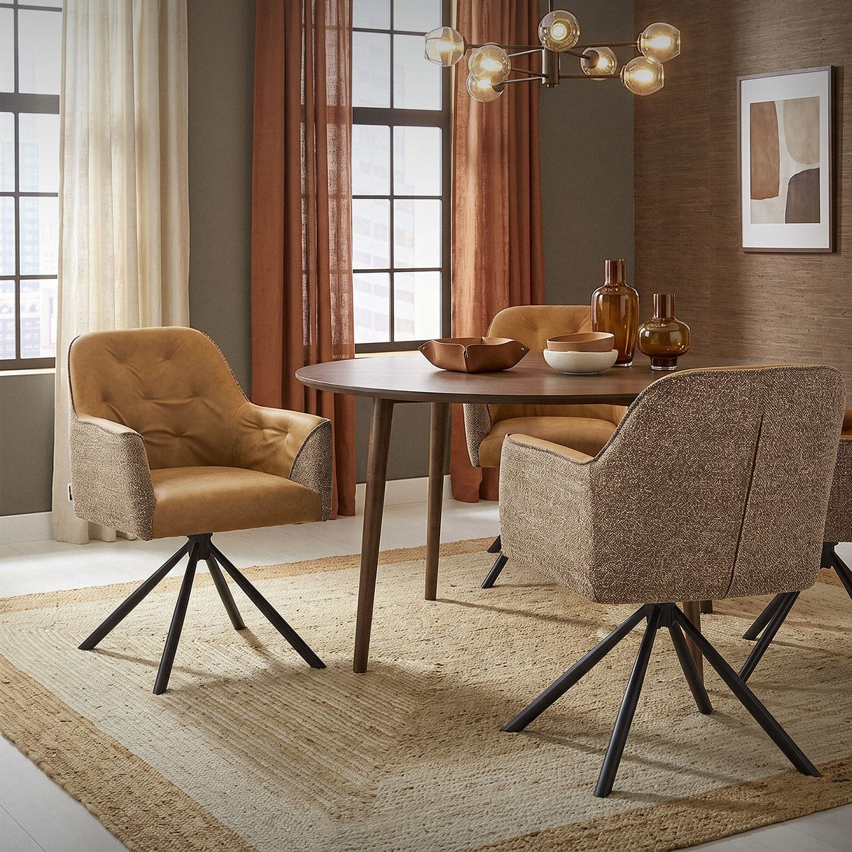 Living room with a round dining table and upholstered swivel chairs in brown and beige.