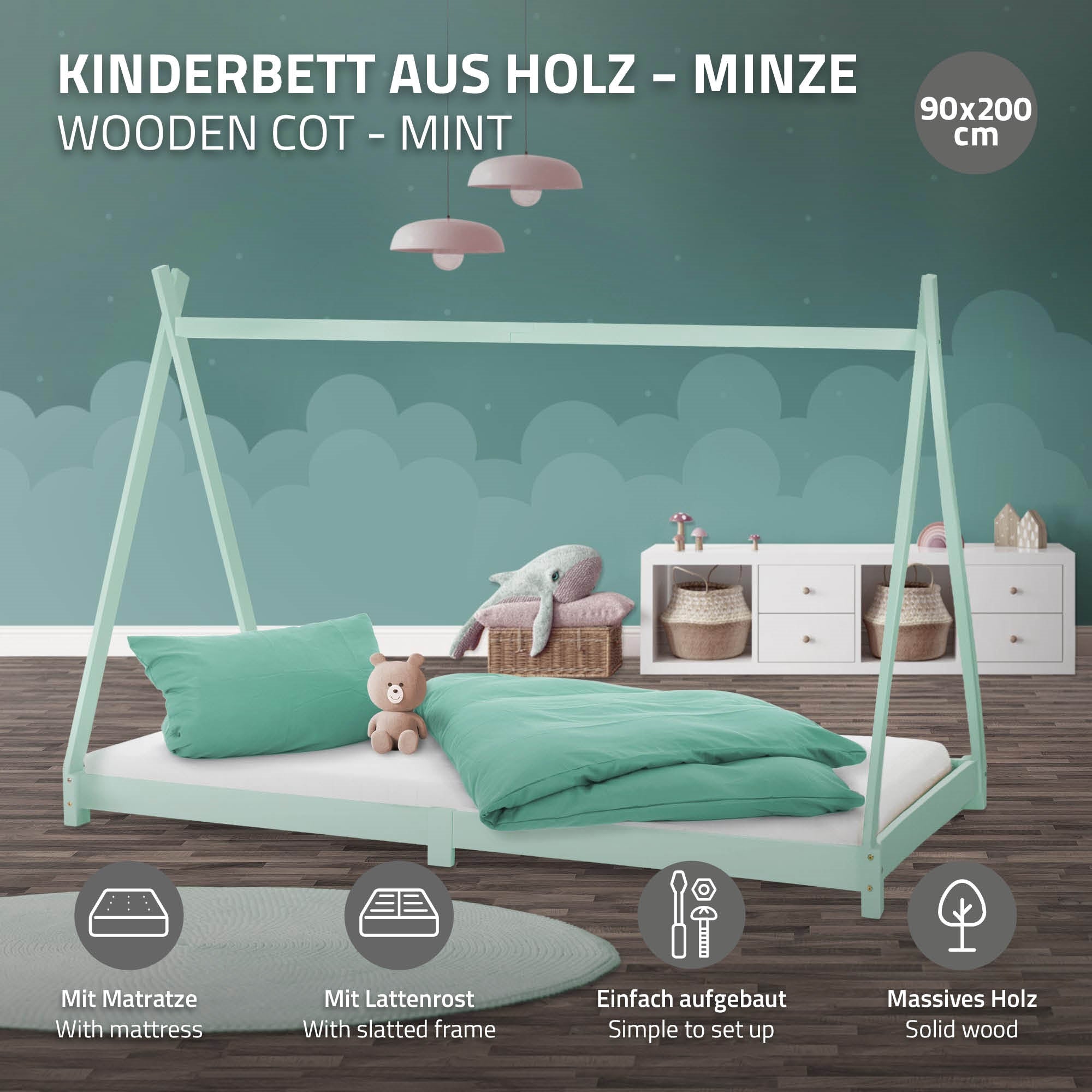 Lit d'enfant en bois couleur menthe avec matelas et coussin.