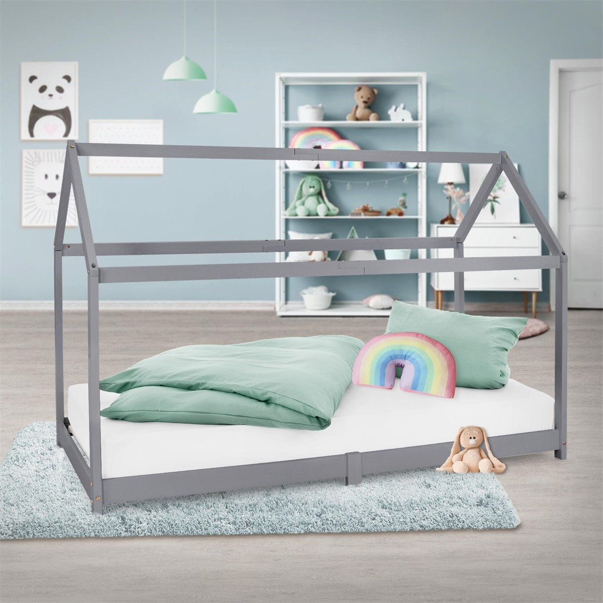 Grey house bed with a white mattress, mint-green bedding and a rainbow cushion in a child’s bedroom.