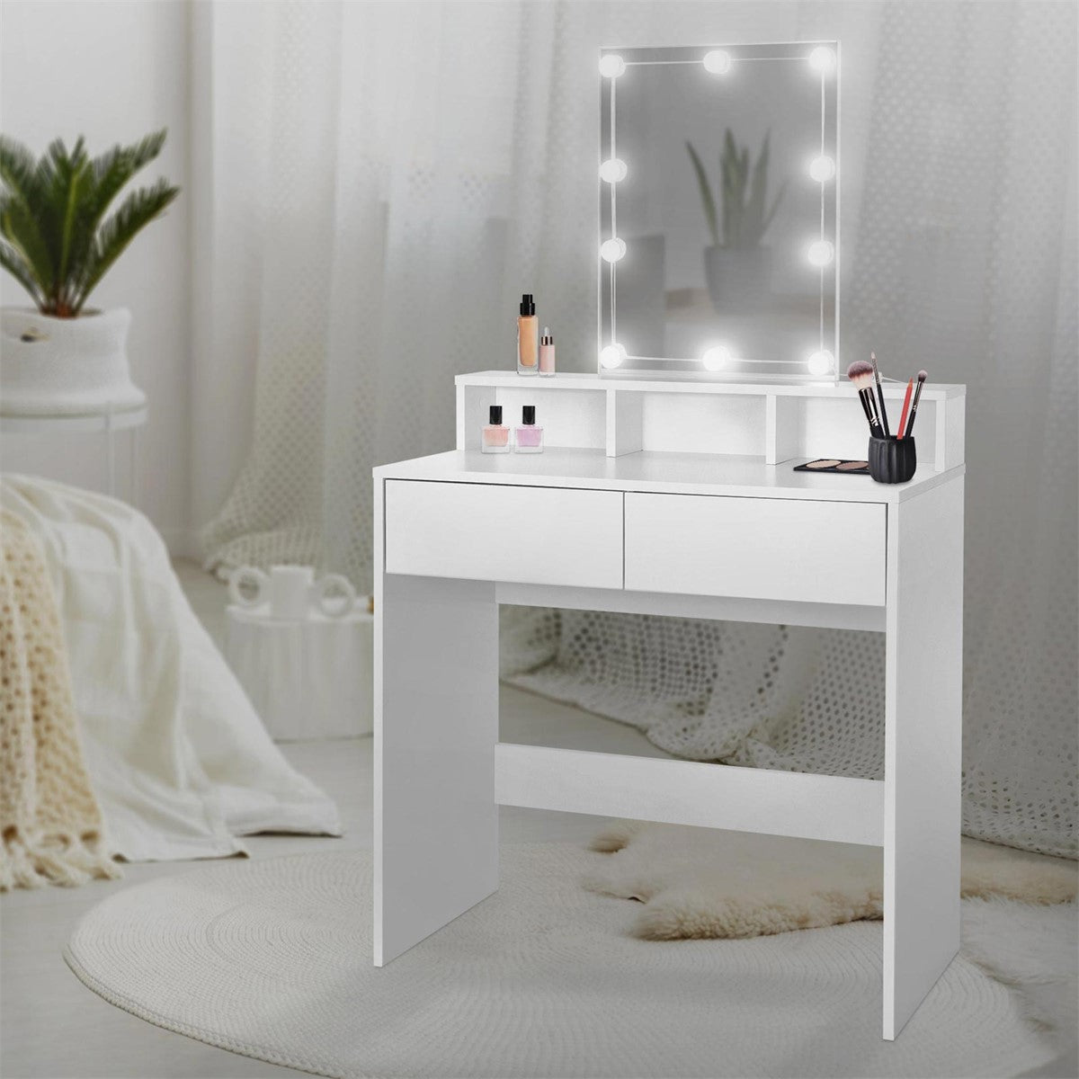 White dressing table with mirror and lighting in a bright room.