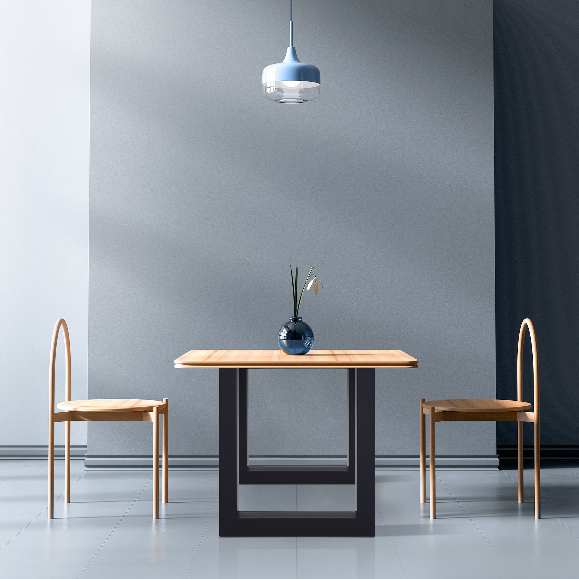 Room with a table, two chairs, and a lamp, bright walls and floor.