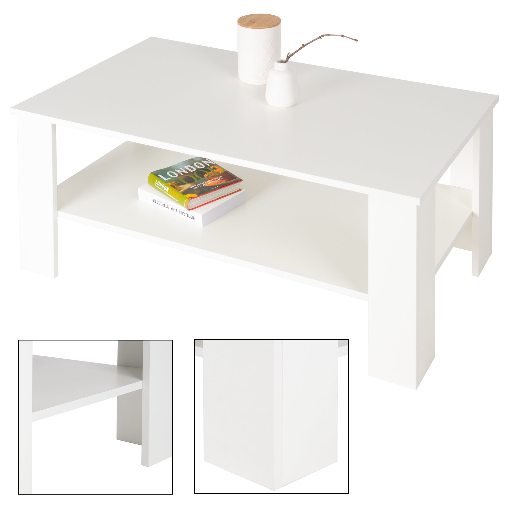 Mesa de café blanca con una revista y dos objetos decorativos en la superficie.
