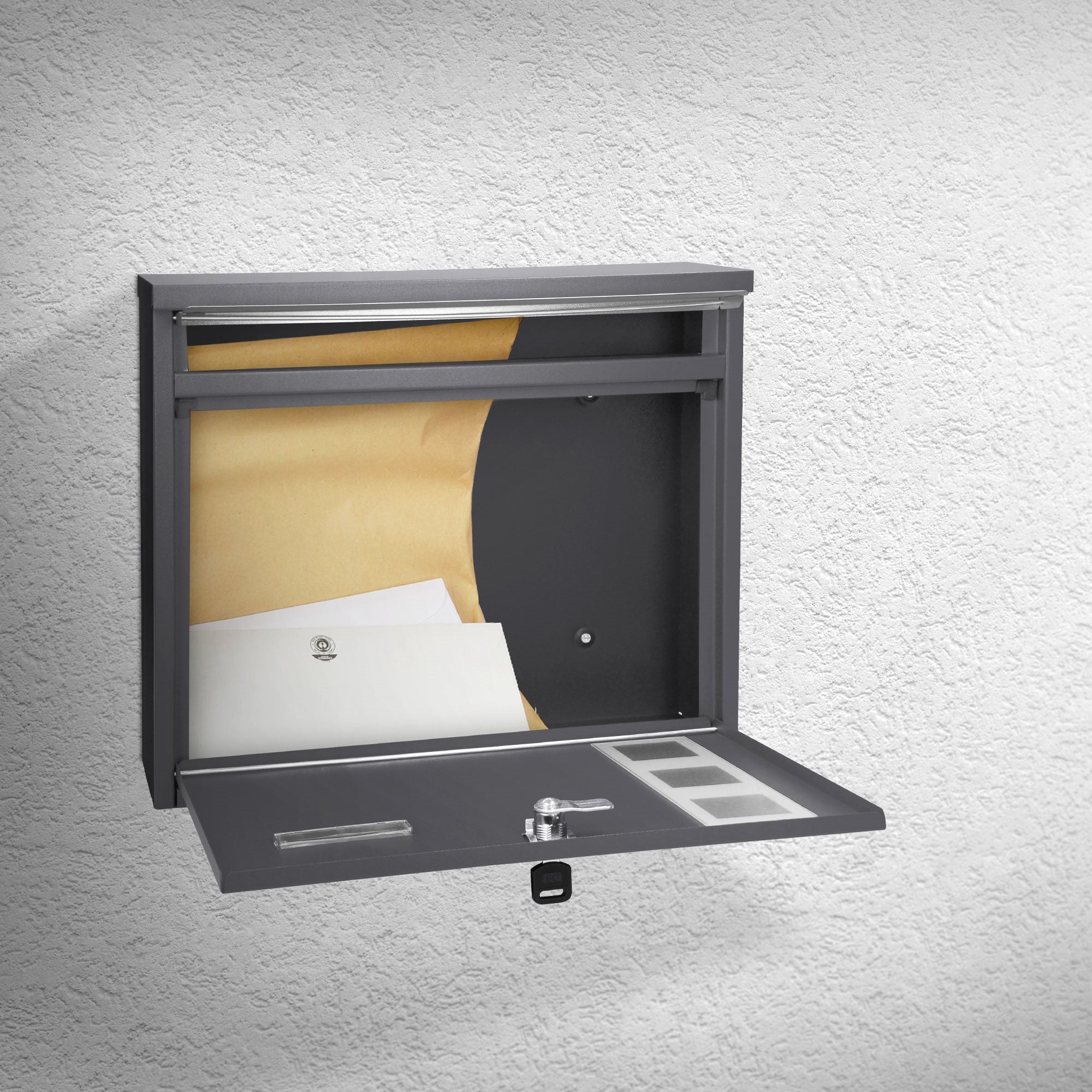 A charcoal gray mailbox with an open flap and view of the interior.