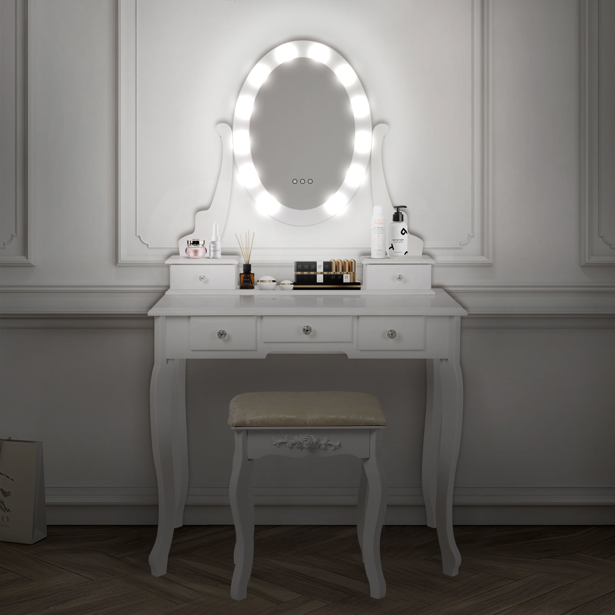 White dressing table with mirror and lighting.