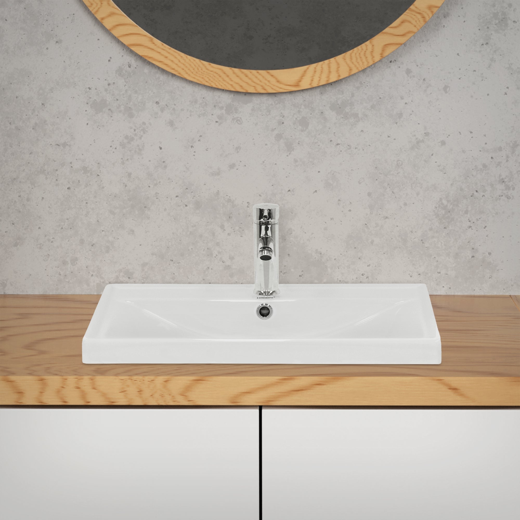 Sink on a wooden cabinet in front of a wall with a mirror.