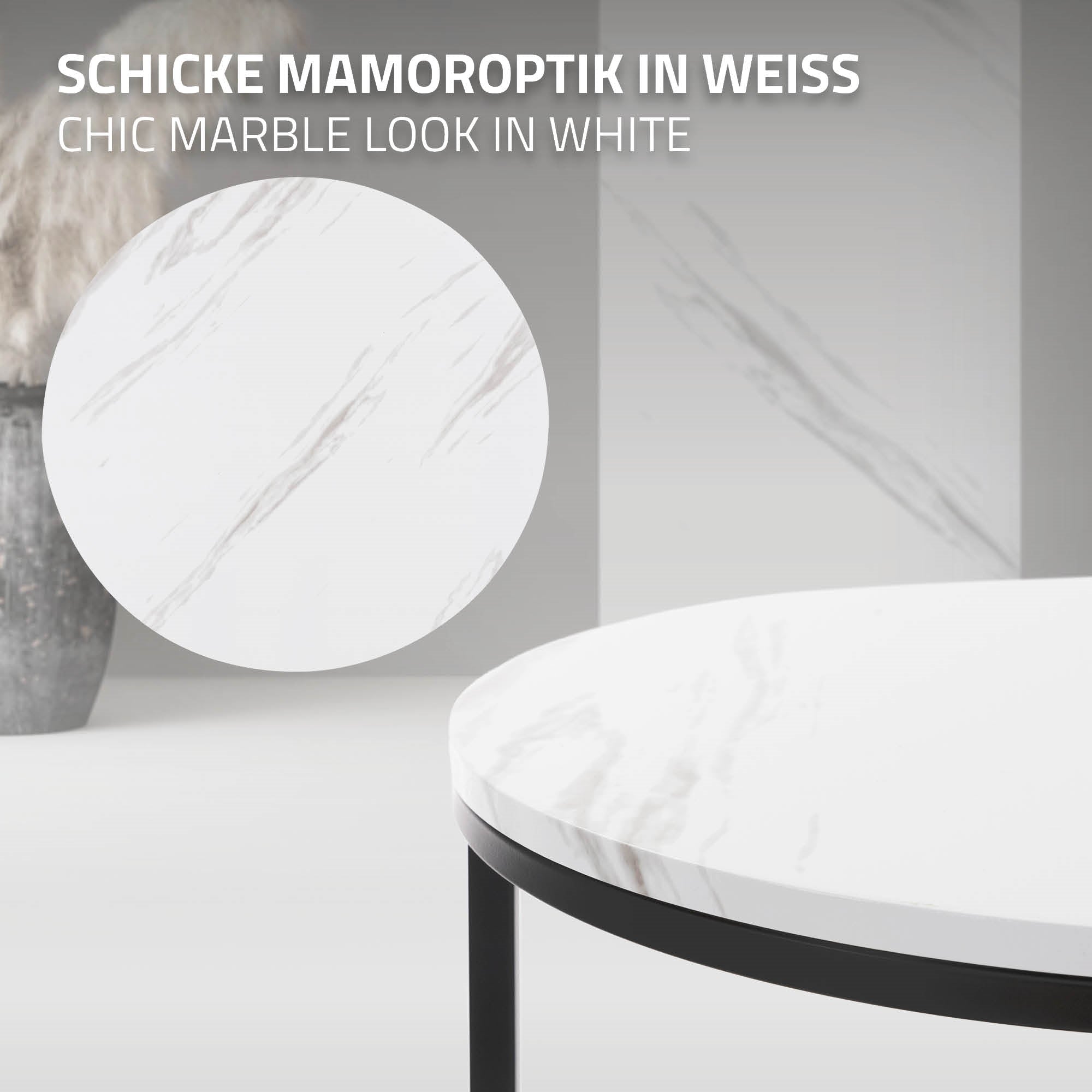 Runder Tisch mit weißer Marmoroptik und schwarzem Gestell.
