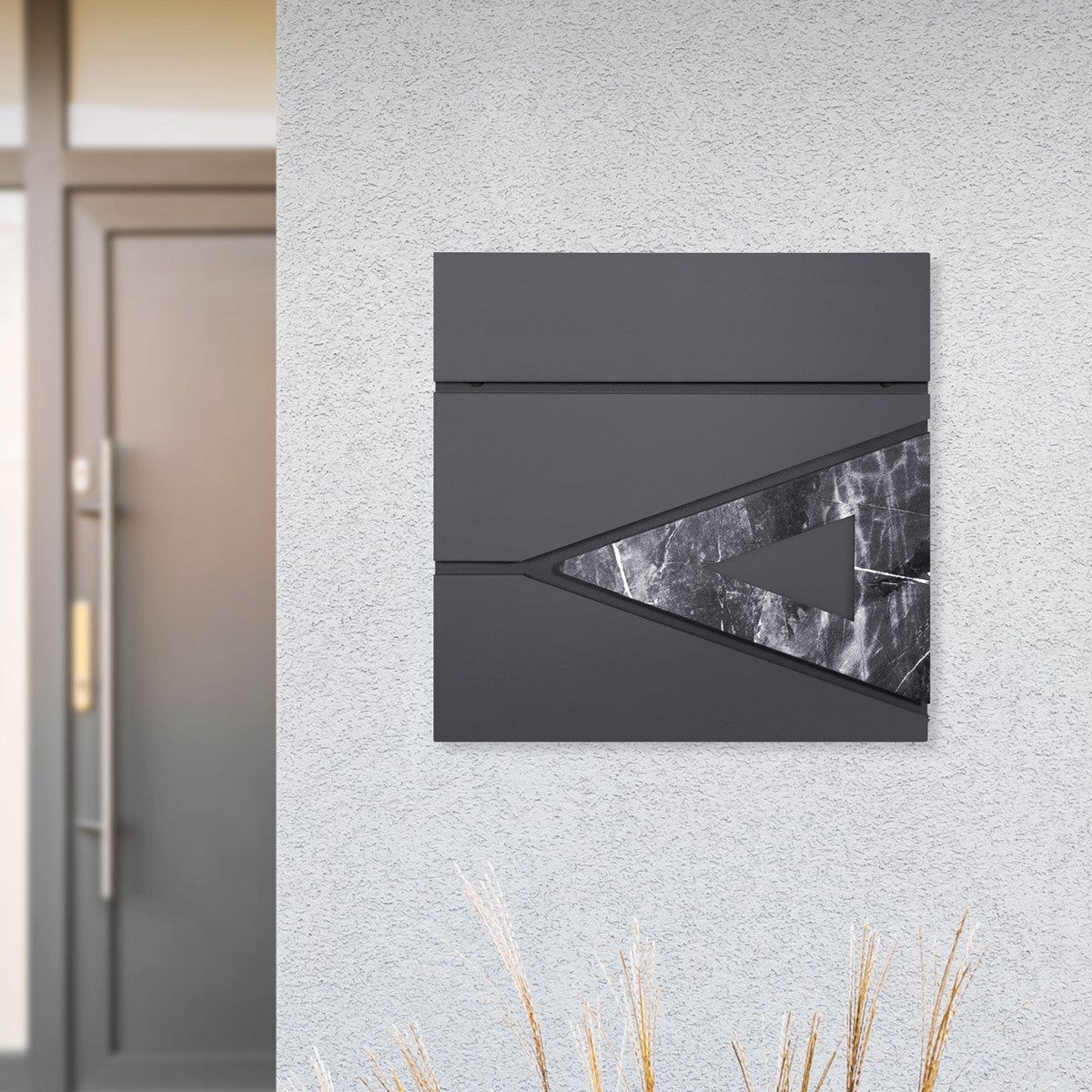 Modern mailbox system on a wall with a gray surface.