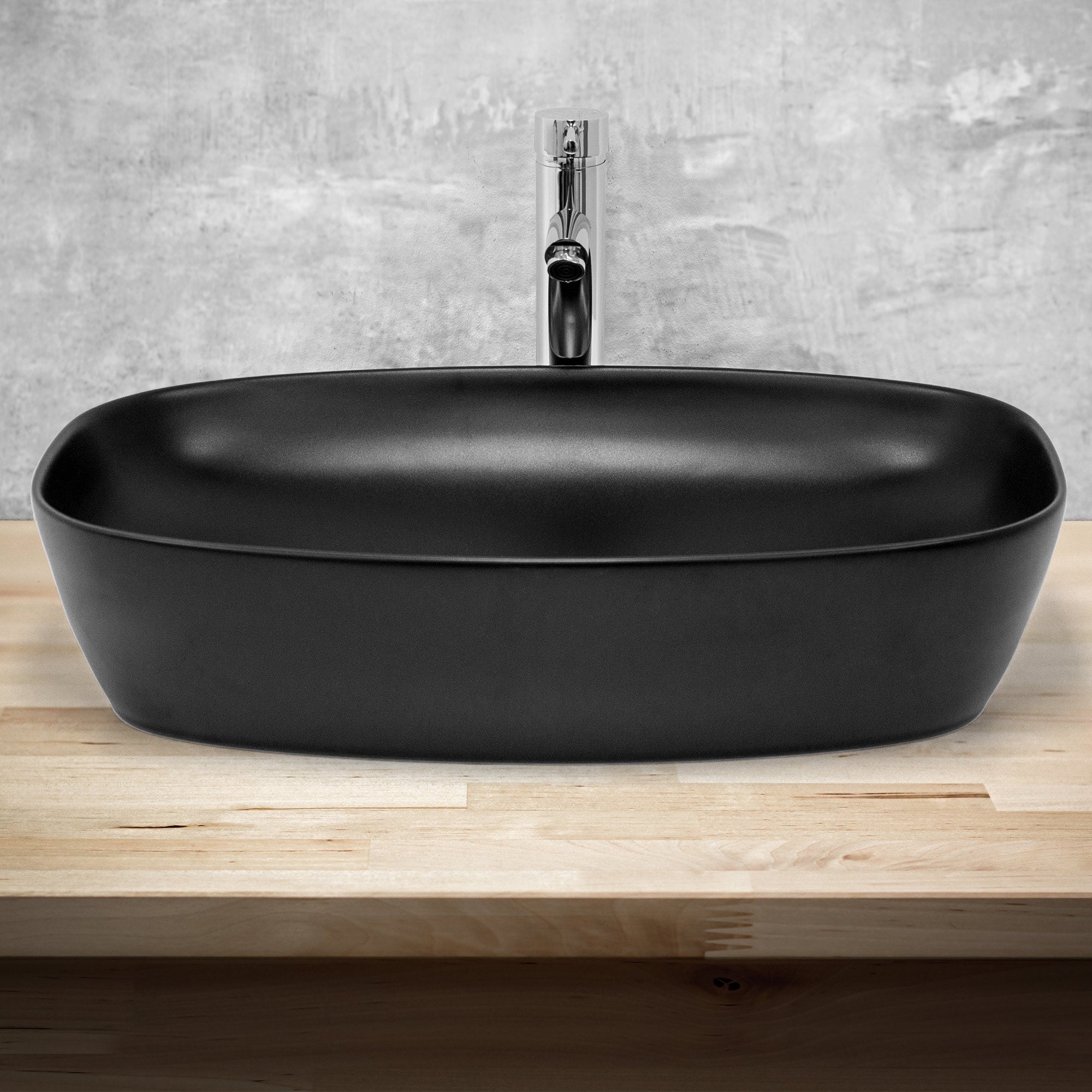 Black oval sink on a wooden base.