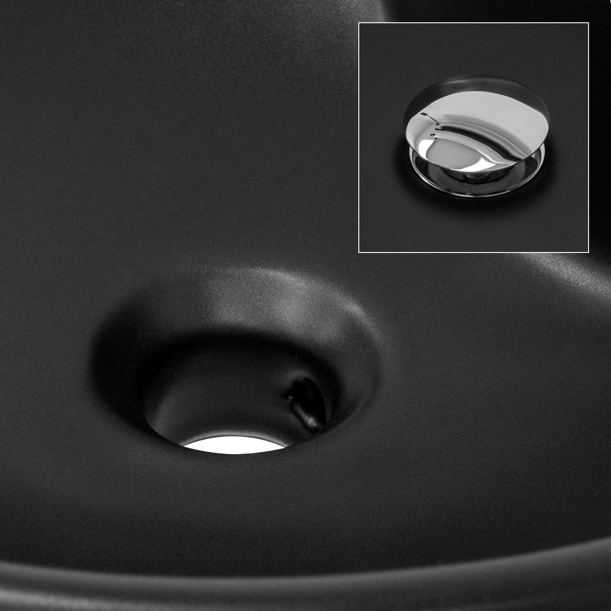 Close-up of the drain of a black sink.