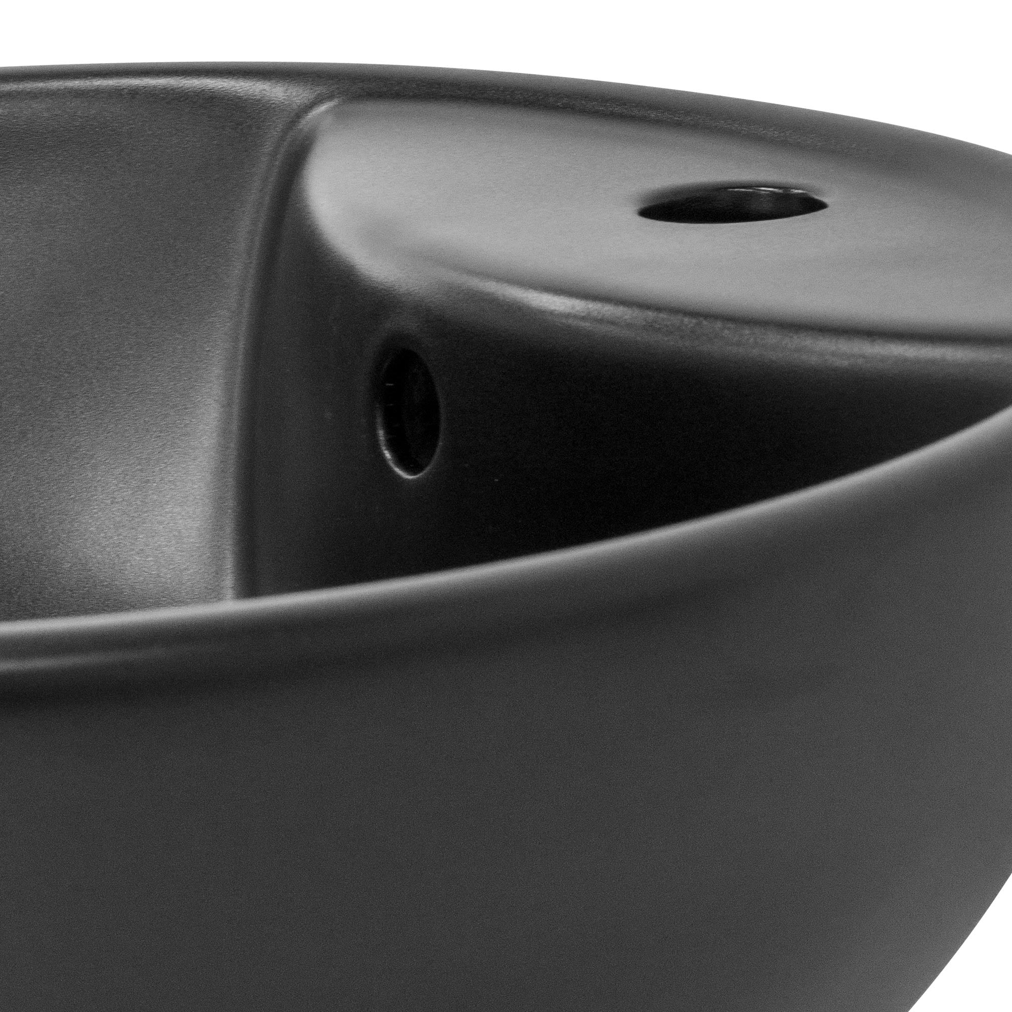 Close-up of a black bowl with a hole and a curved edge.